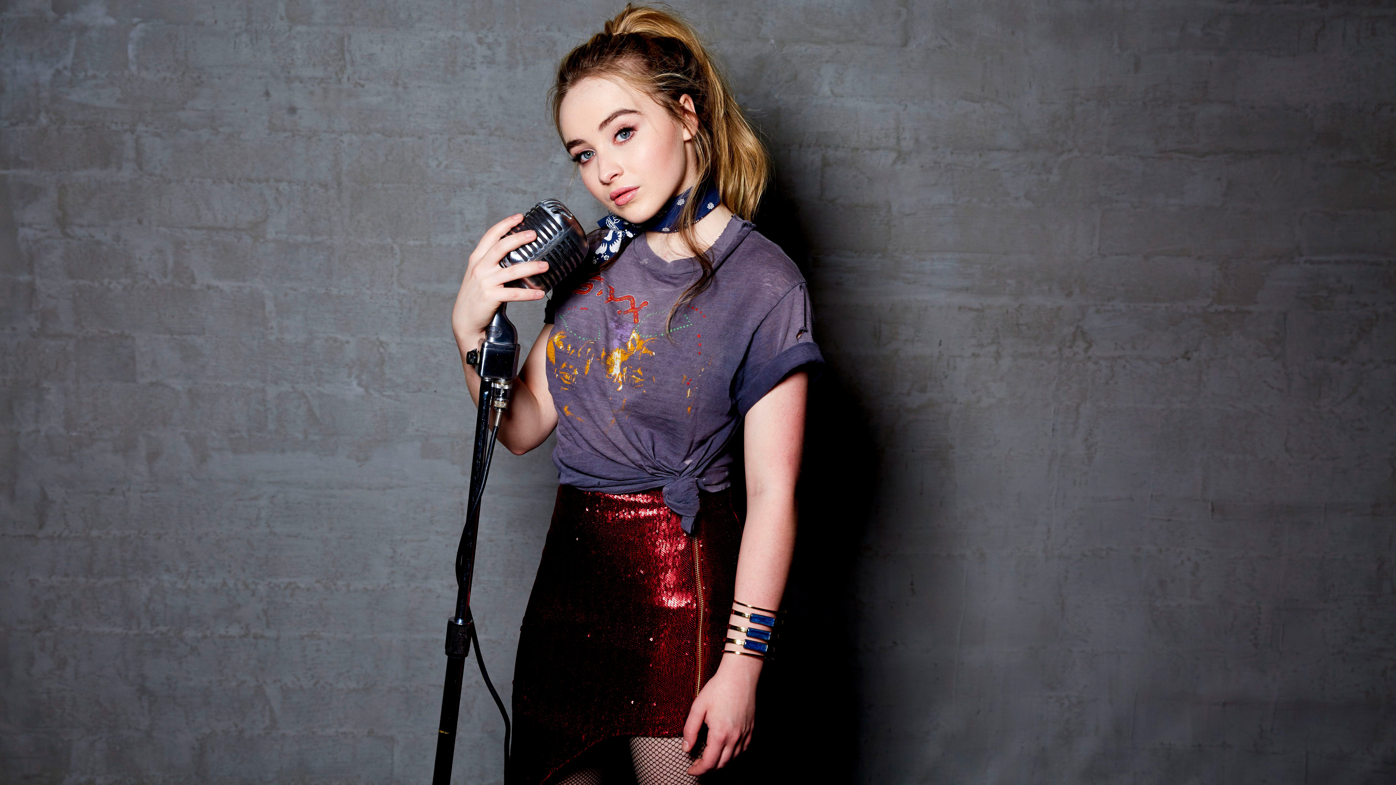 Sabrina Carpenter with microphone HD Wallpaper