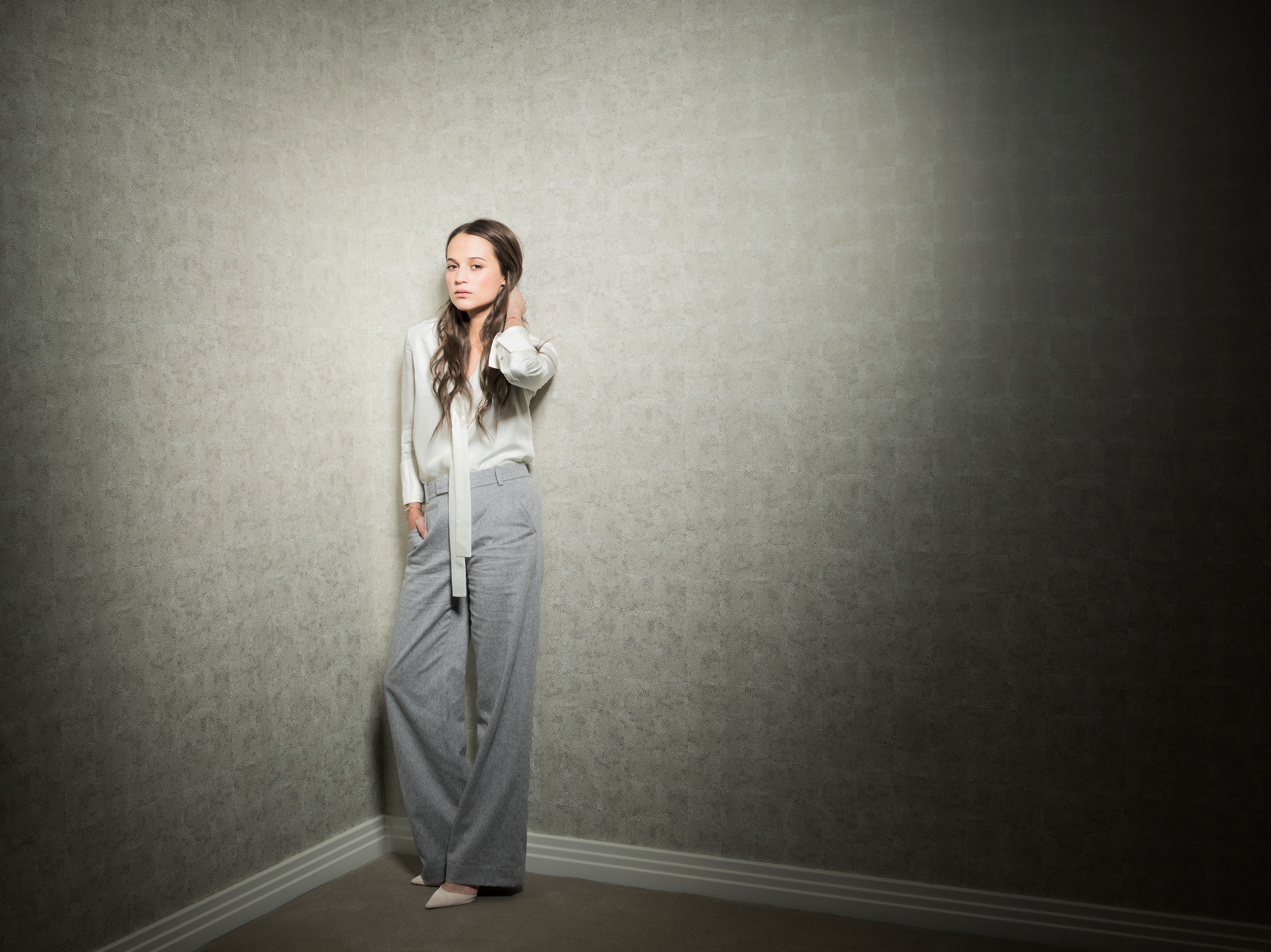 Alicia Vikander in a corner HD Wallpaper