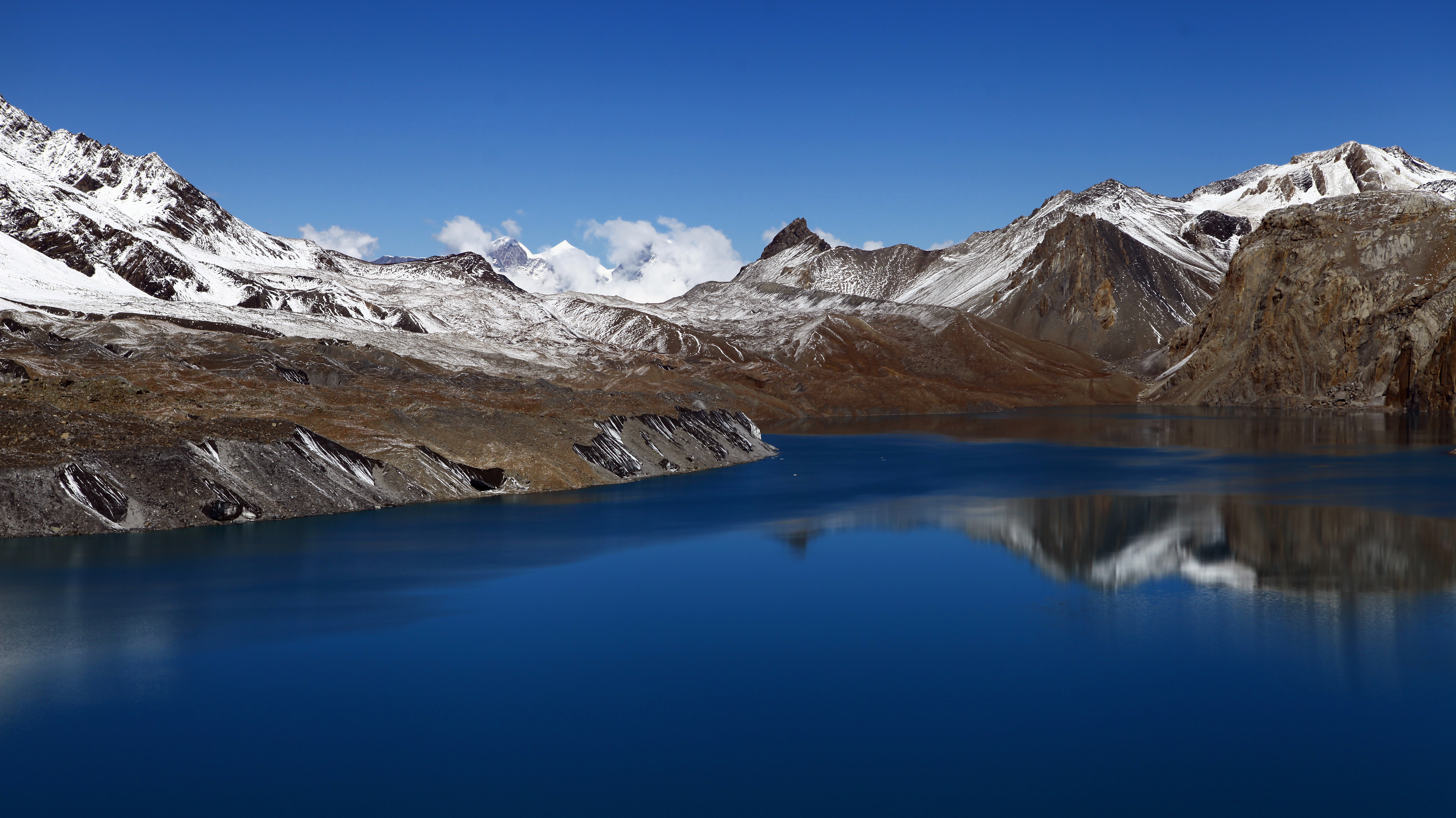 Snowy mountains reflected in a blue lake HD Wallpaper
