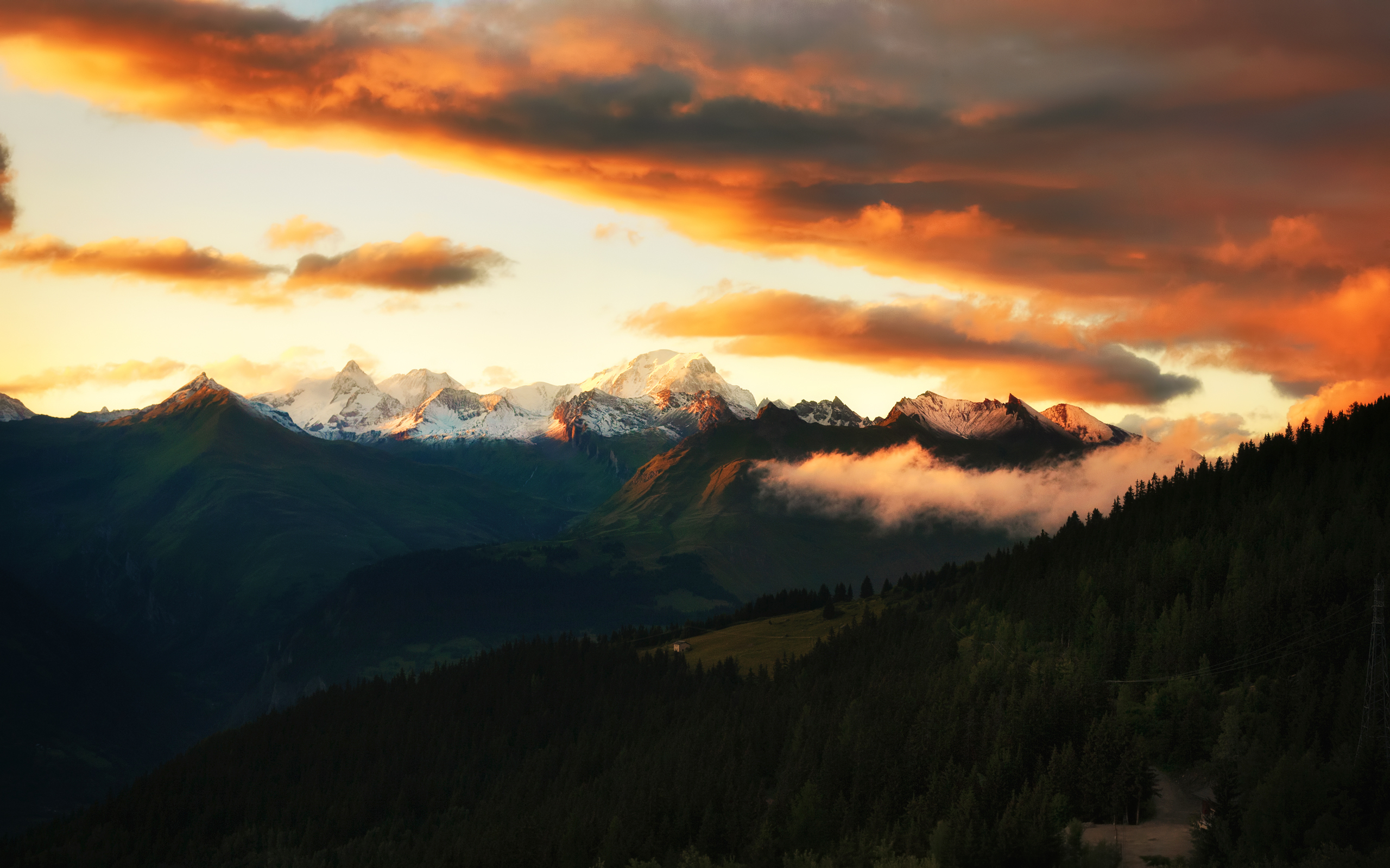 Sunset over snow-capped mountains in the French Alps HD Wallpaper