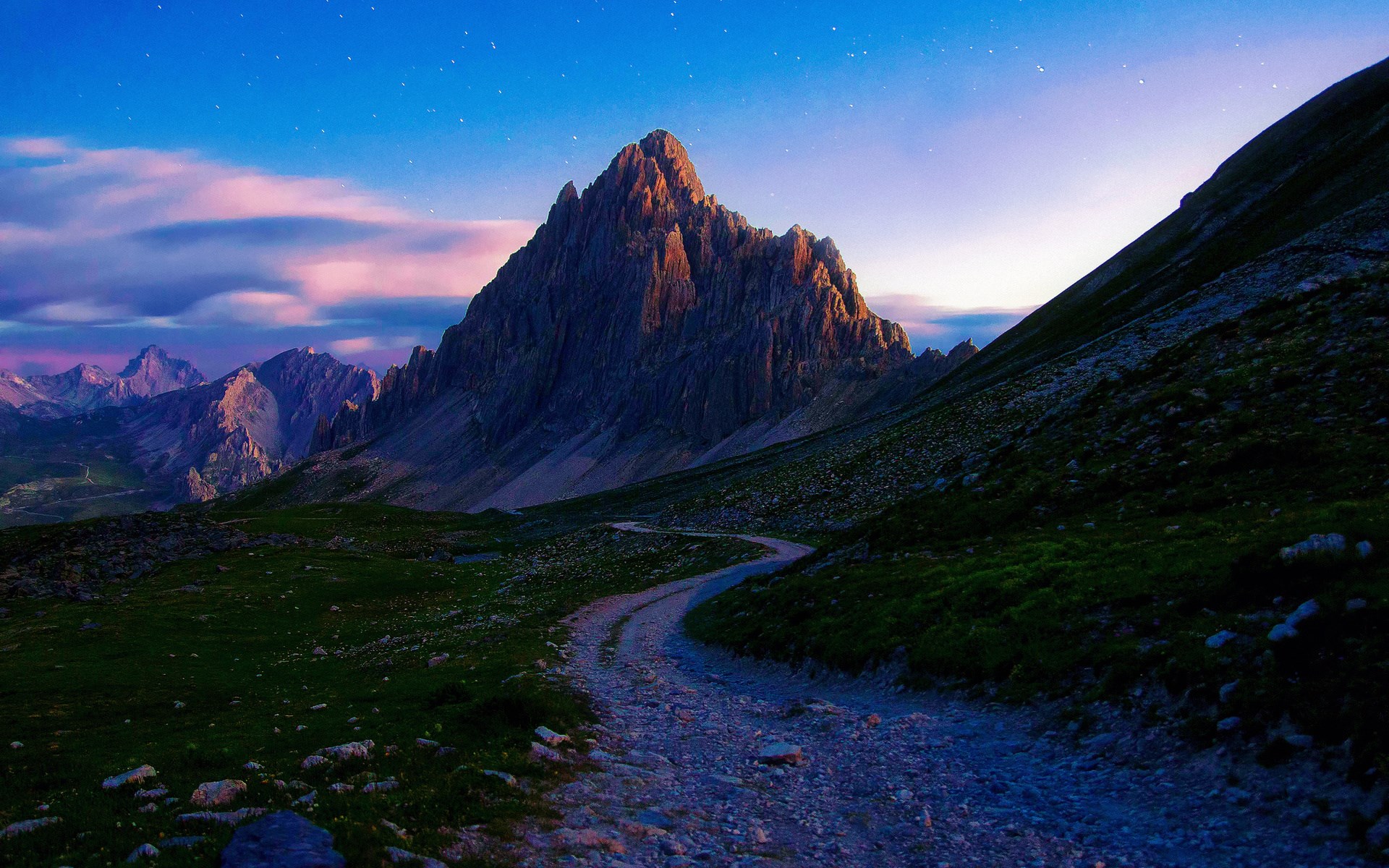 Mountain landscape with a winding path at dusk HD Wallpaper