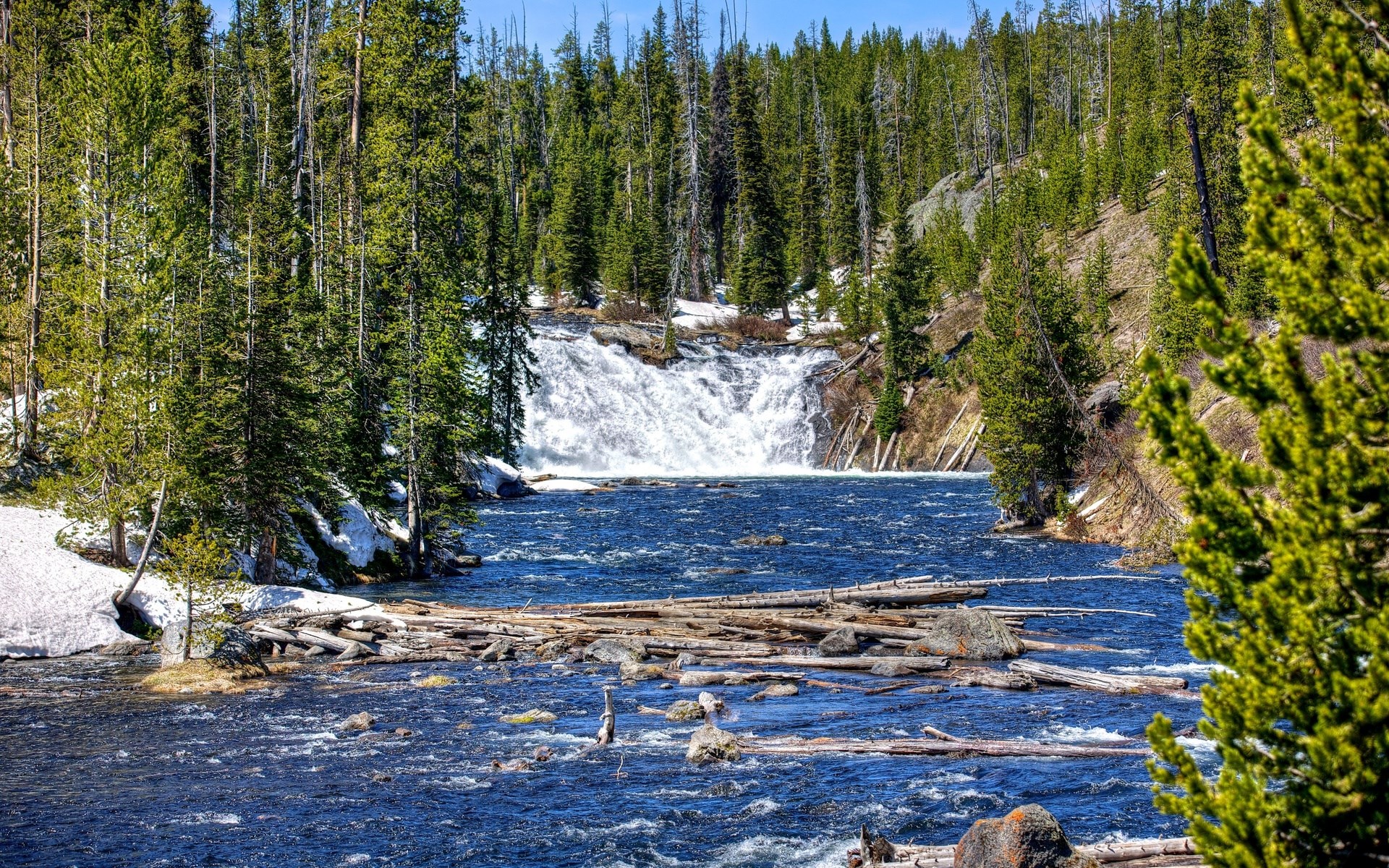 River flowing past a waterfall and forest with snow HD Wallpaper