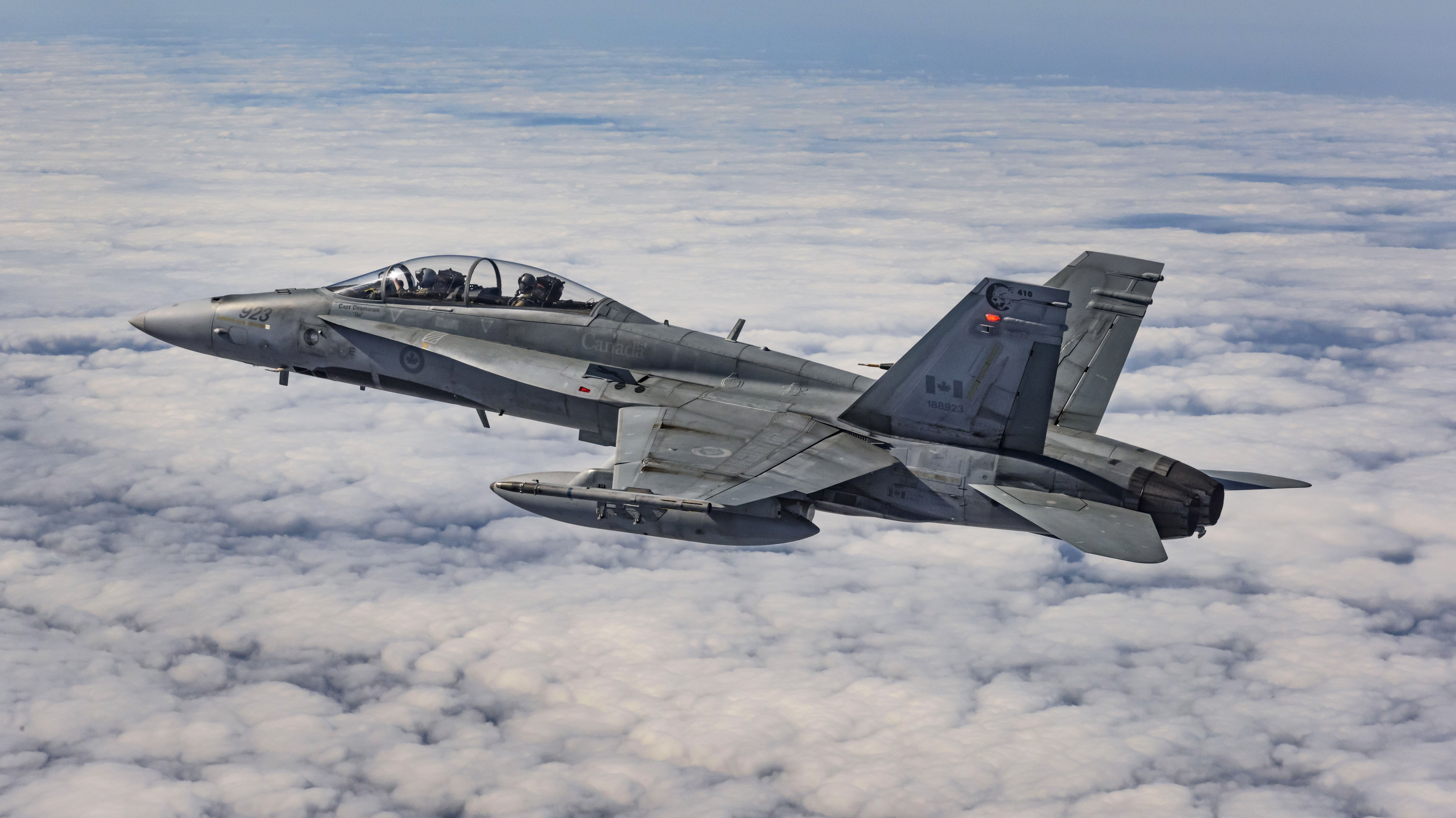 Royal Canadian Air Force CF-18 Hornet flying above clouds HD Wallpaper