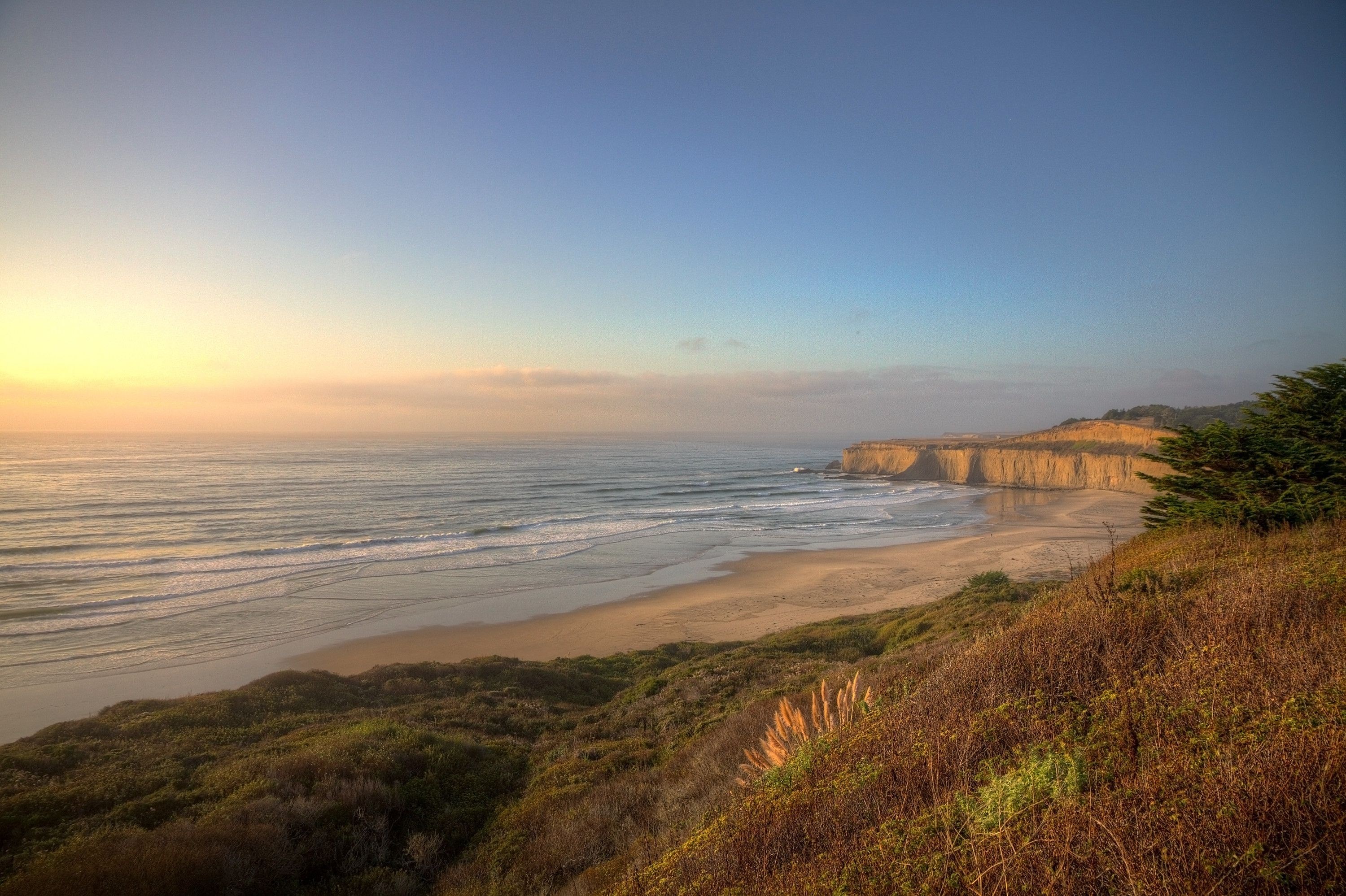 Coastal cliffs and ocean at sunset HD Wallpaper