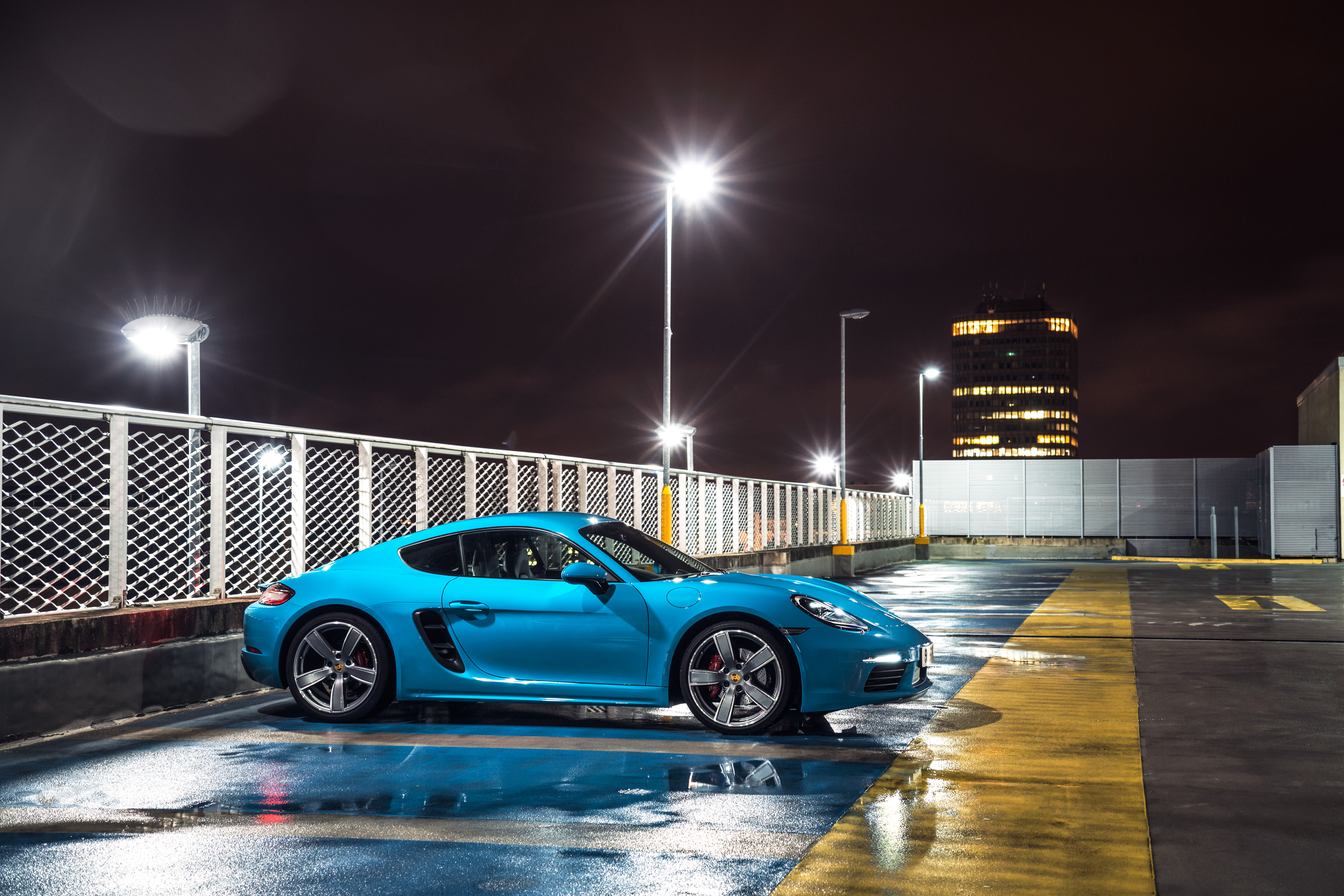 Blue Porsche Cayman S on wet parking lot at night 4K HD Wallpaper