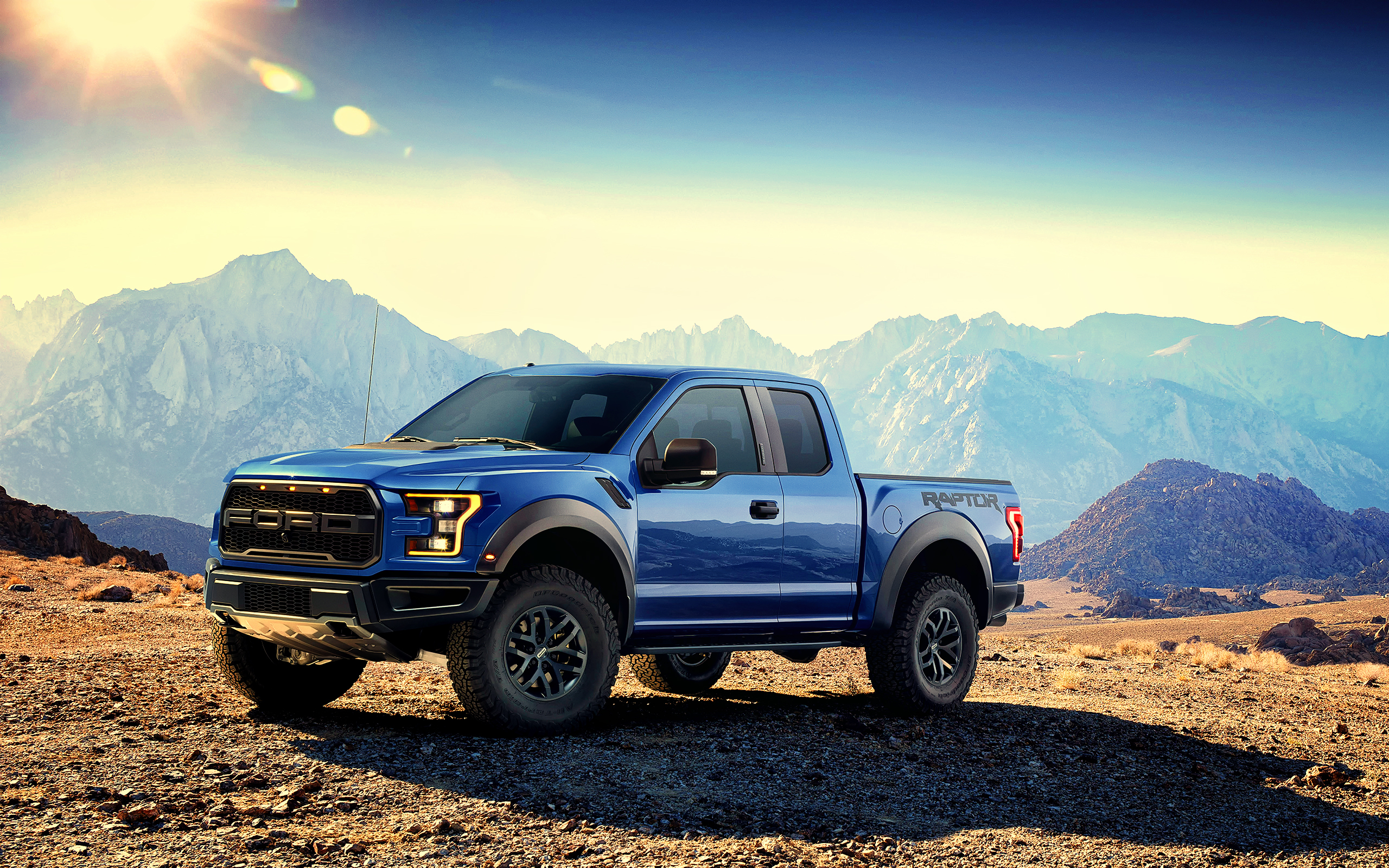 Blue Ford F-150 Raptor pickup truck in mountains HD Wallpaper