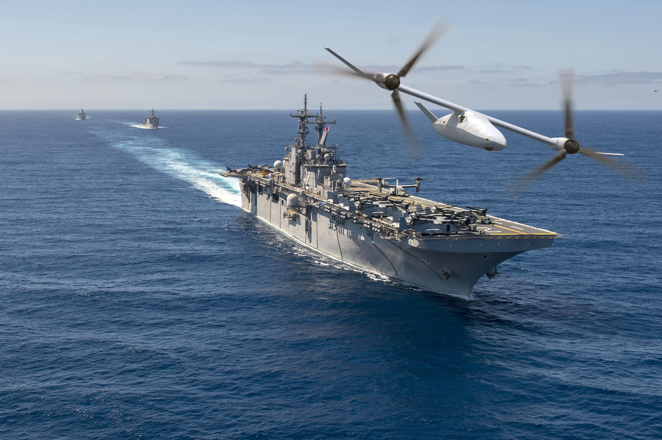 Bell V-247 Vigilant flies over a naval fleet HD Wallpaper