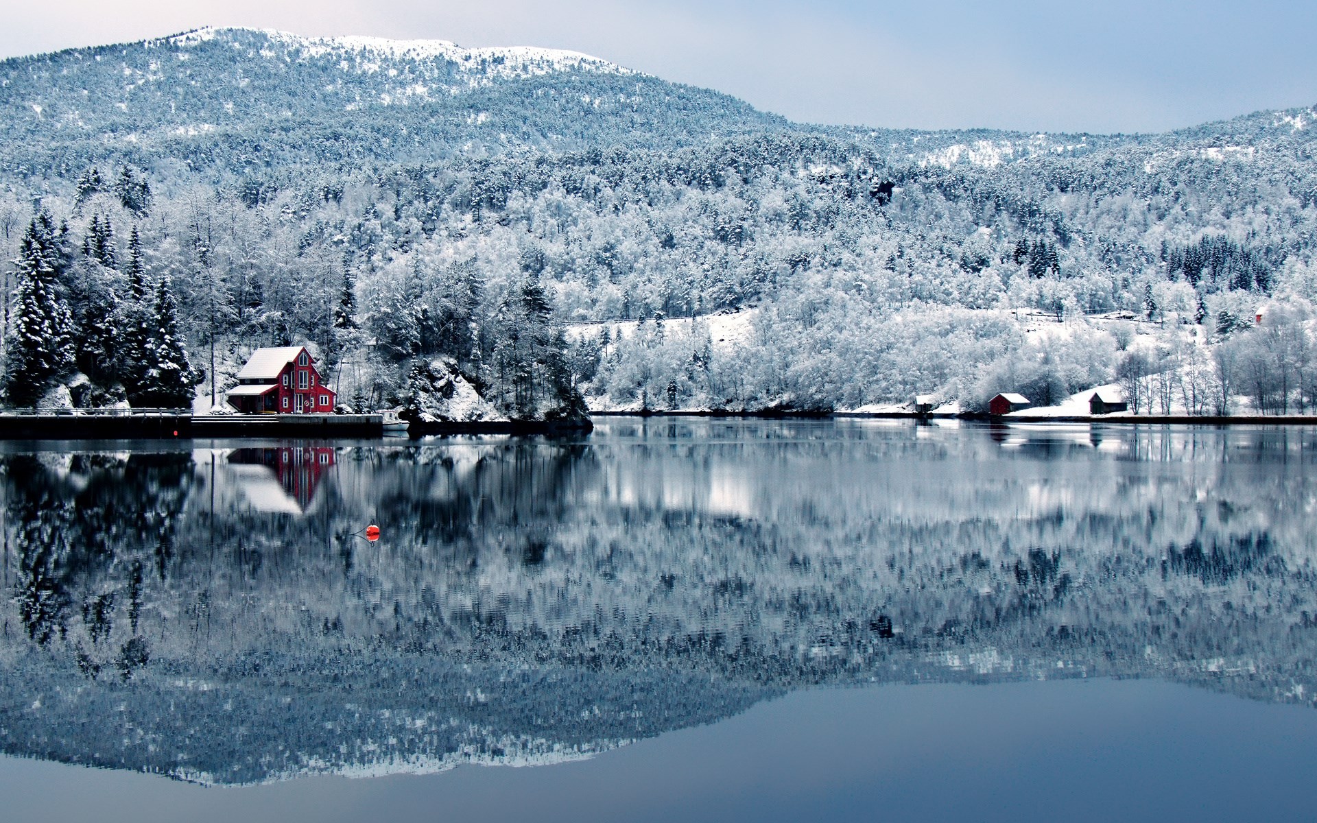Red house on a snowy lake with mountains HD Wallpaper