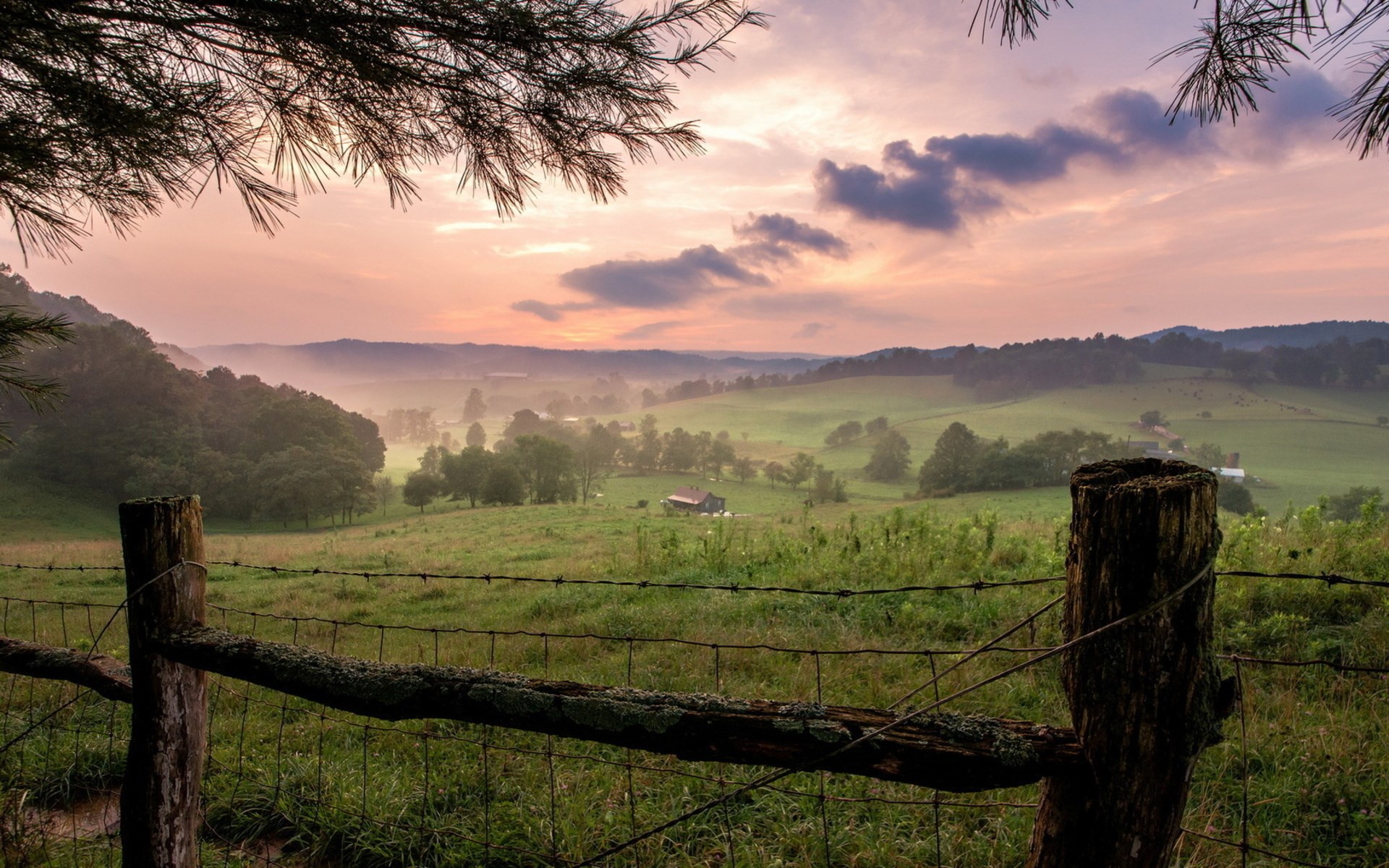 Rural landscape at sunrise with fence and rolling hills HD Wallpaper