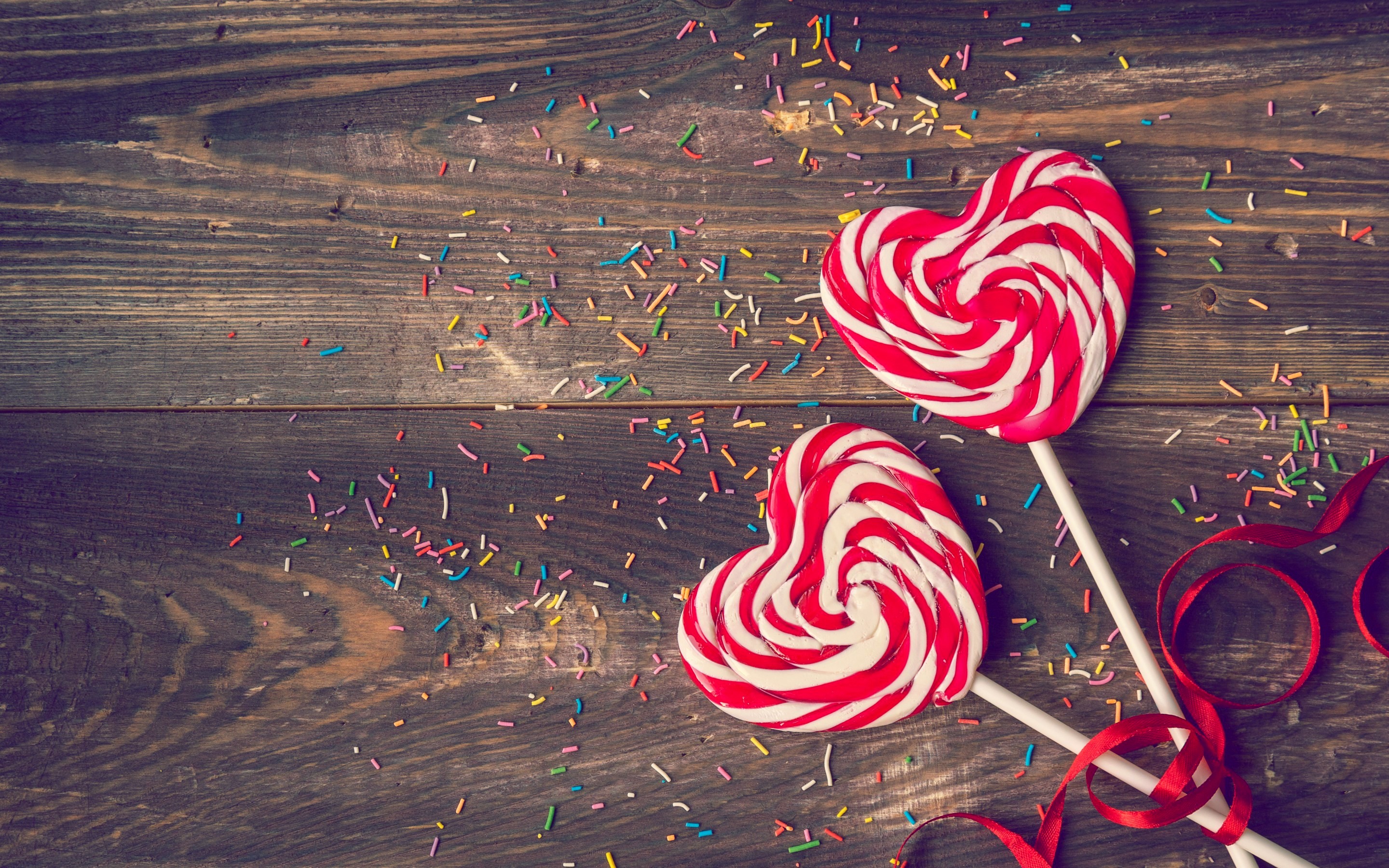 Heart-shaped lollipops with sprinkles and ribbon HD Wallpaper