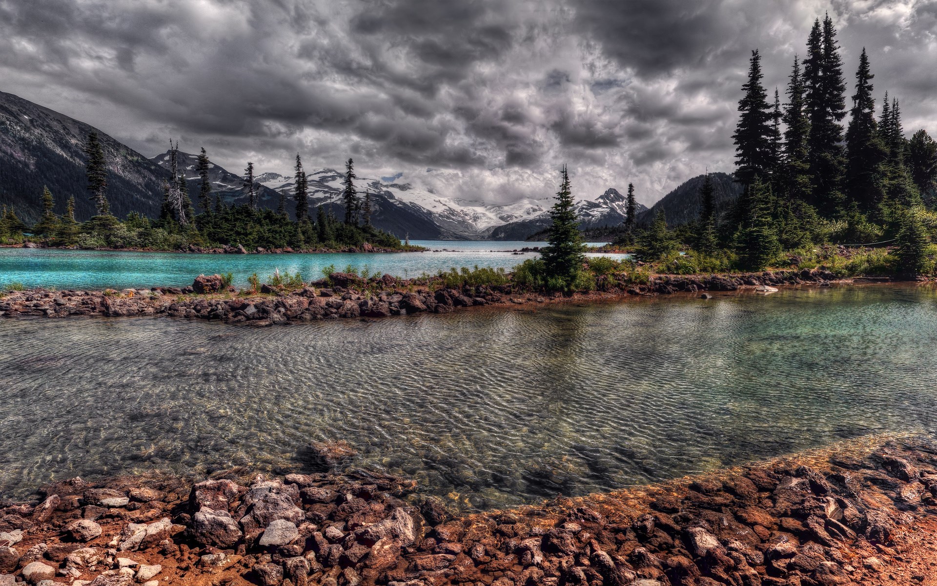 Turquoise lake and mountains under cloudy sky HD Wallpaper