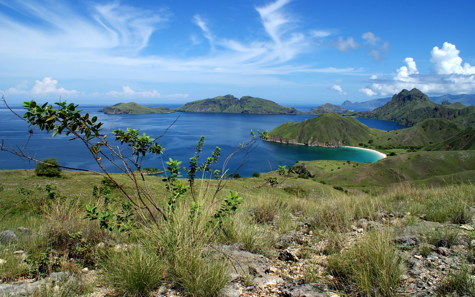Island landscape with green hills and blue ocean HD Wallpaper