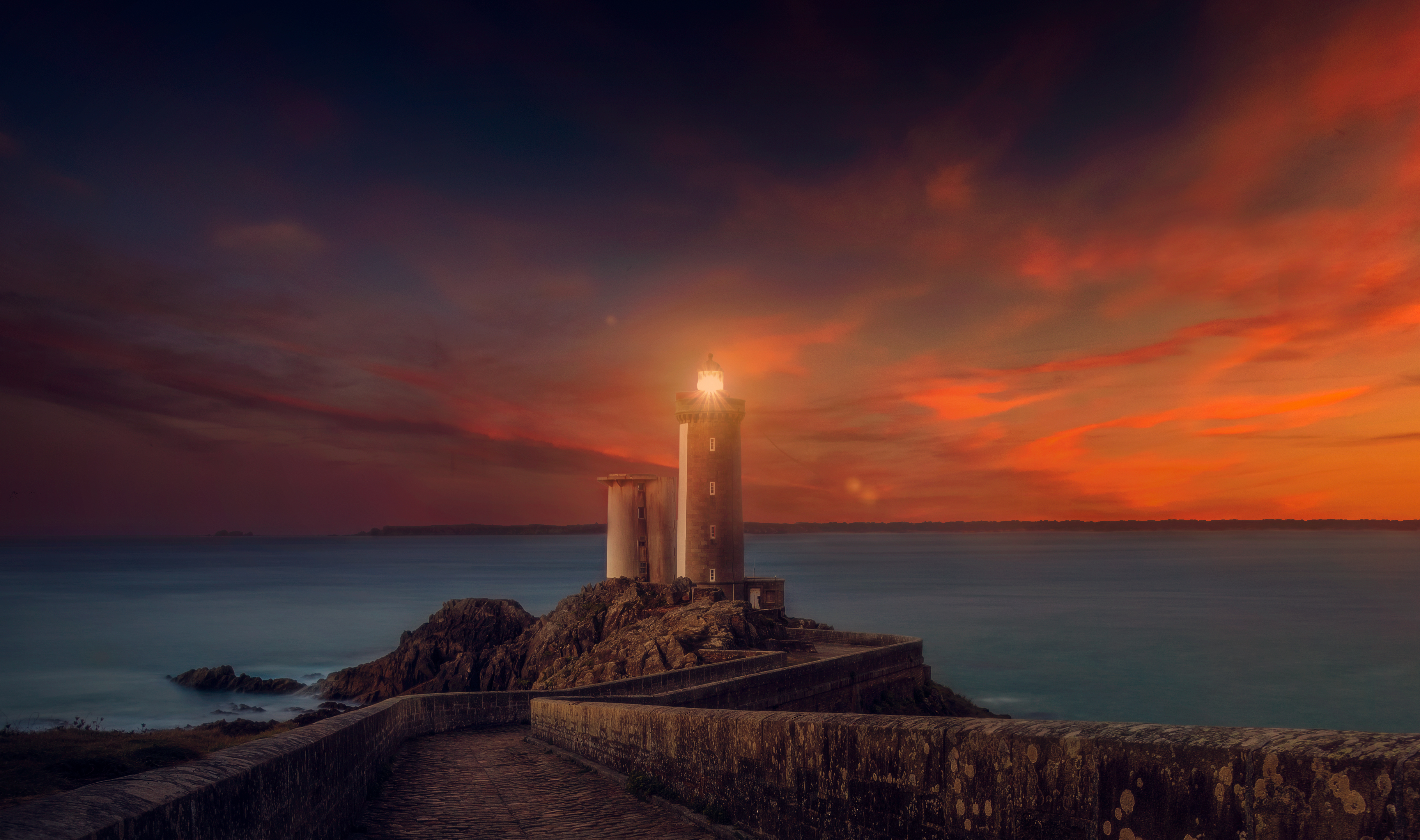4K Sunset Lighthouse on Rocky Coast HD Wallpaper