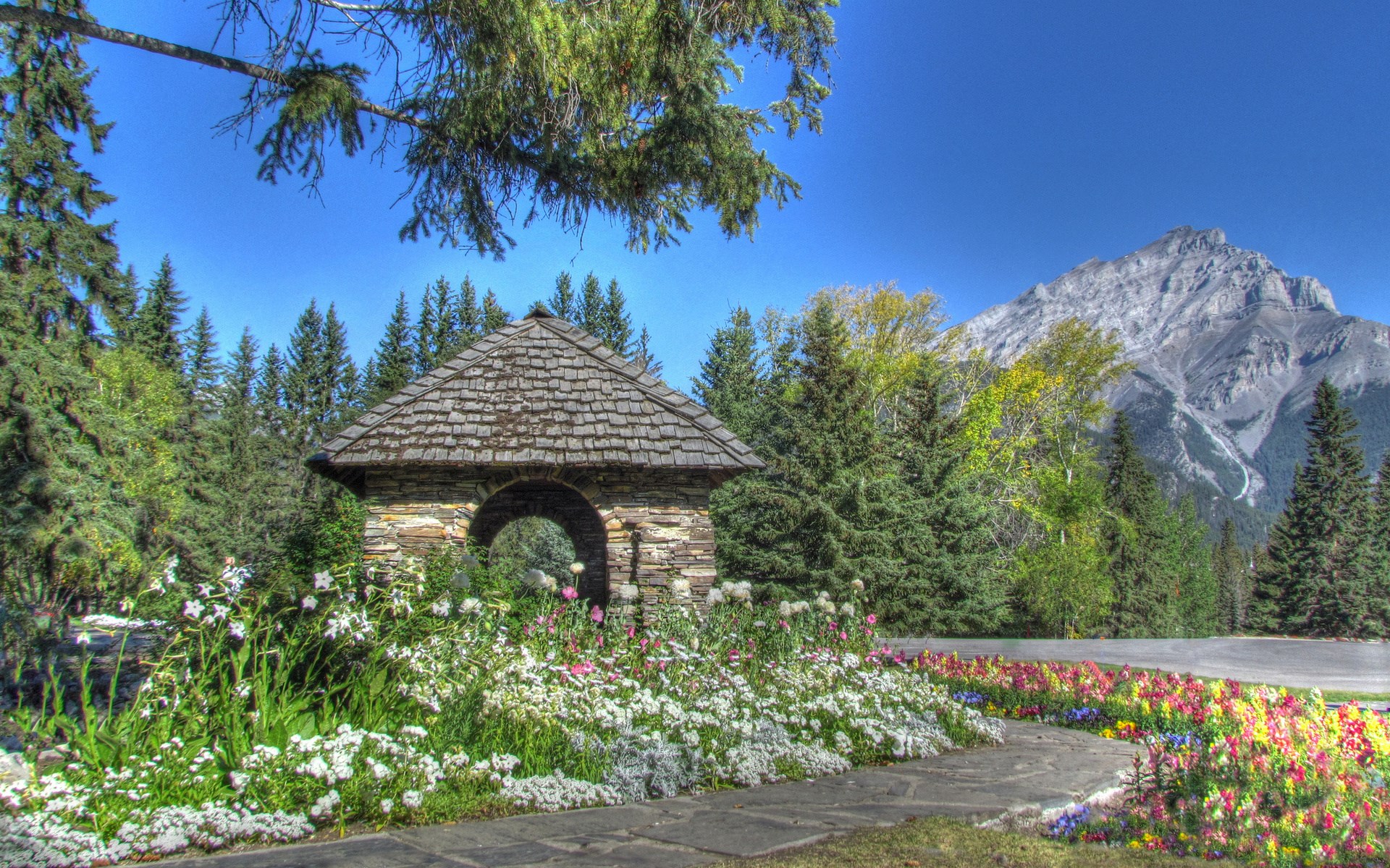 Stone Gazebo in a Garden with Mountains HD Wallpaper