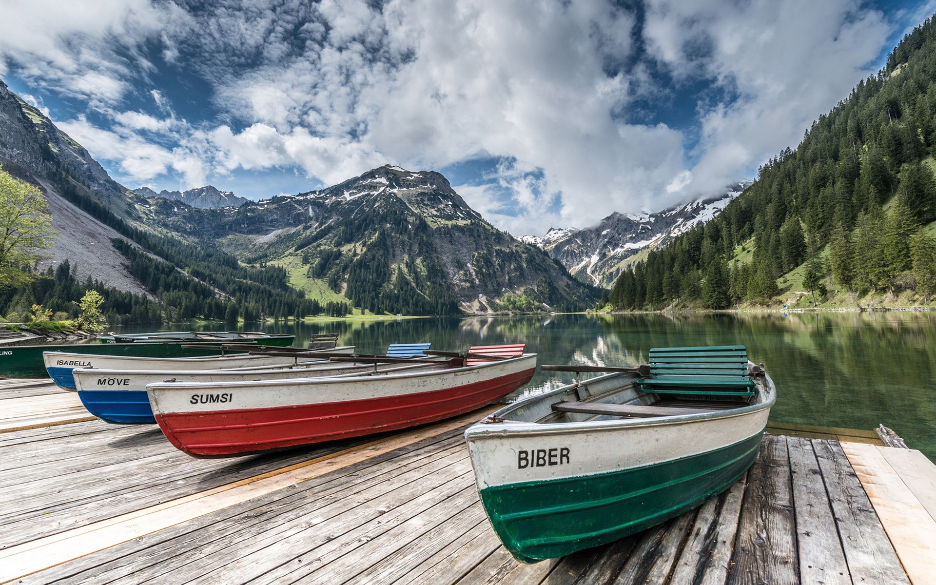 Boats on a wooden dock at a mountain lake HD Wallpaper