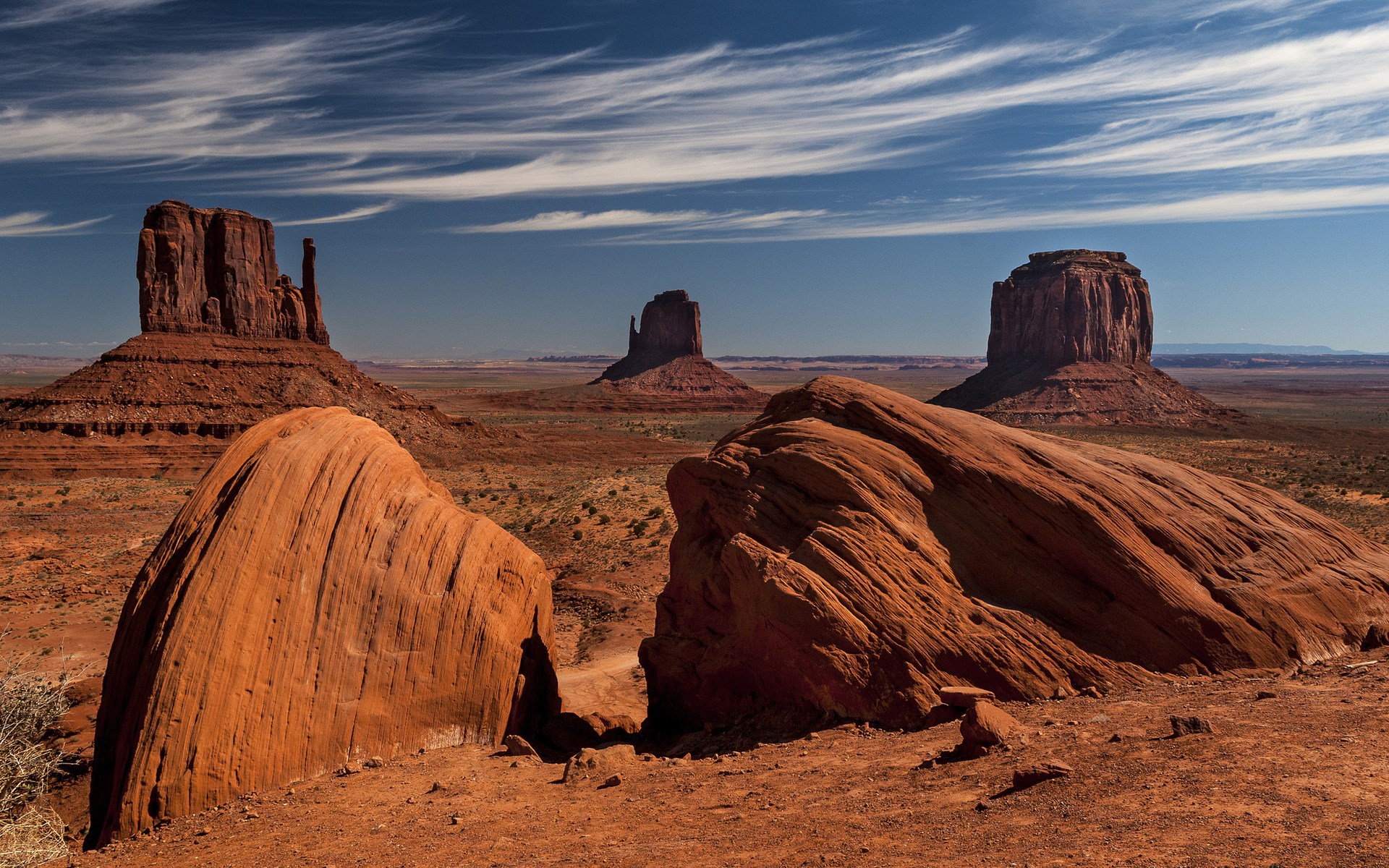 Monument Valley landscape with mesas and rock formations HD Wallpaper