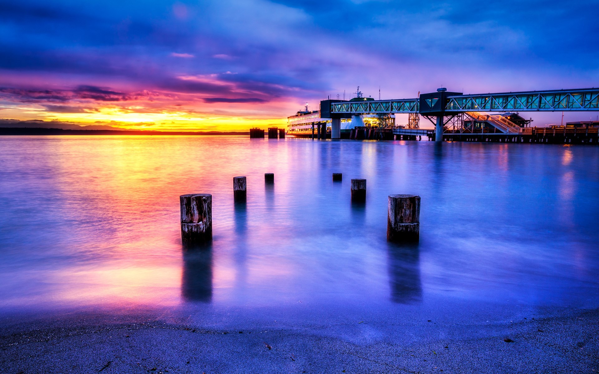 Ferry terminal at sunset with colorful sky and water HD Wallpaper