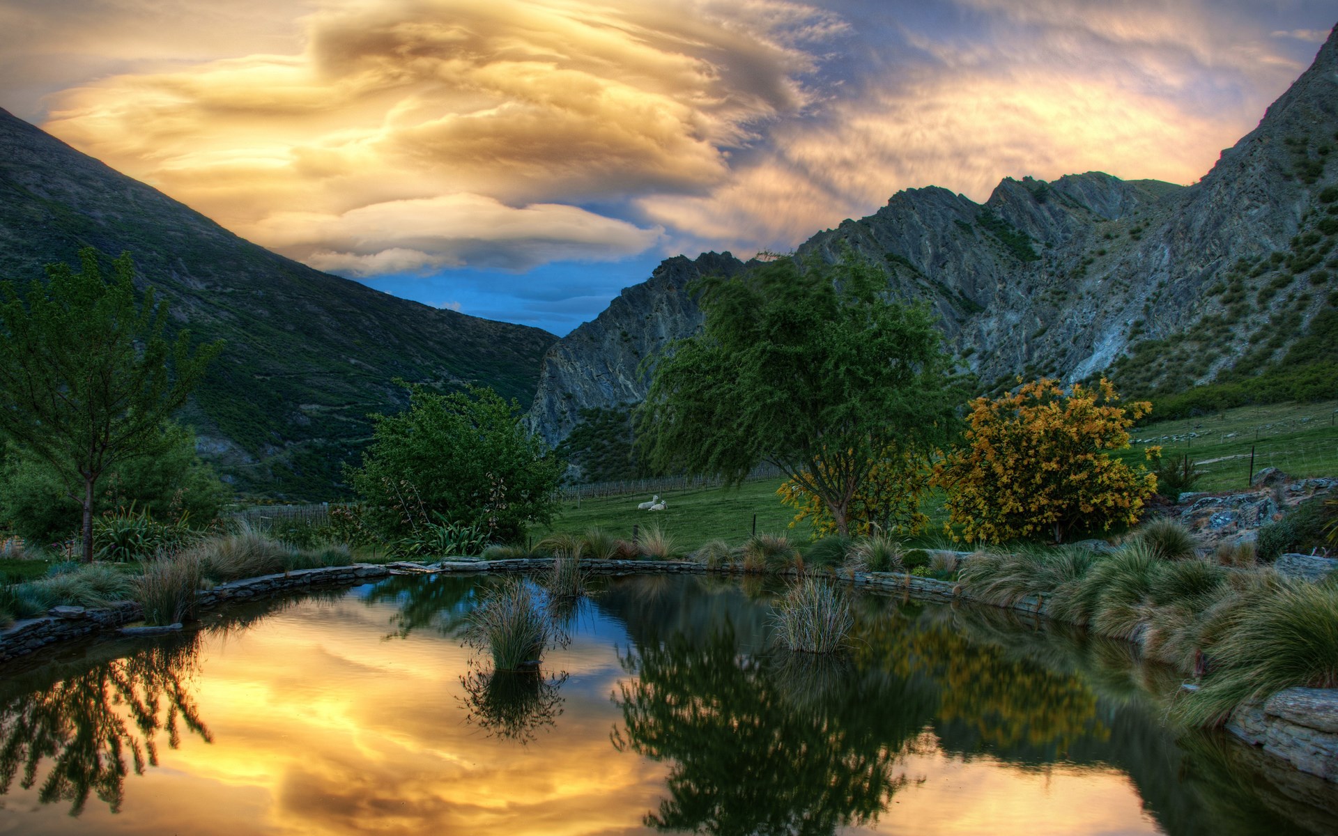 Mountain landscape with a pond reflecting the sky HD Wallpaper