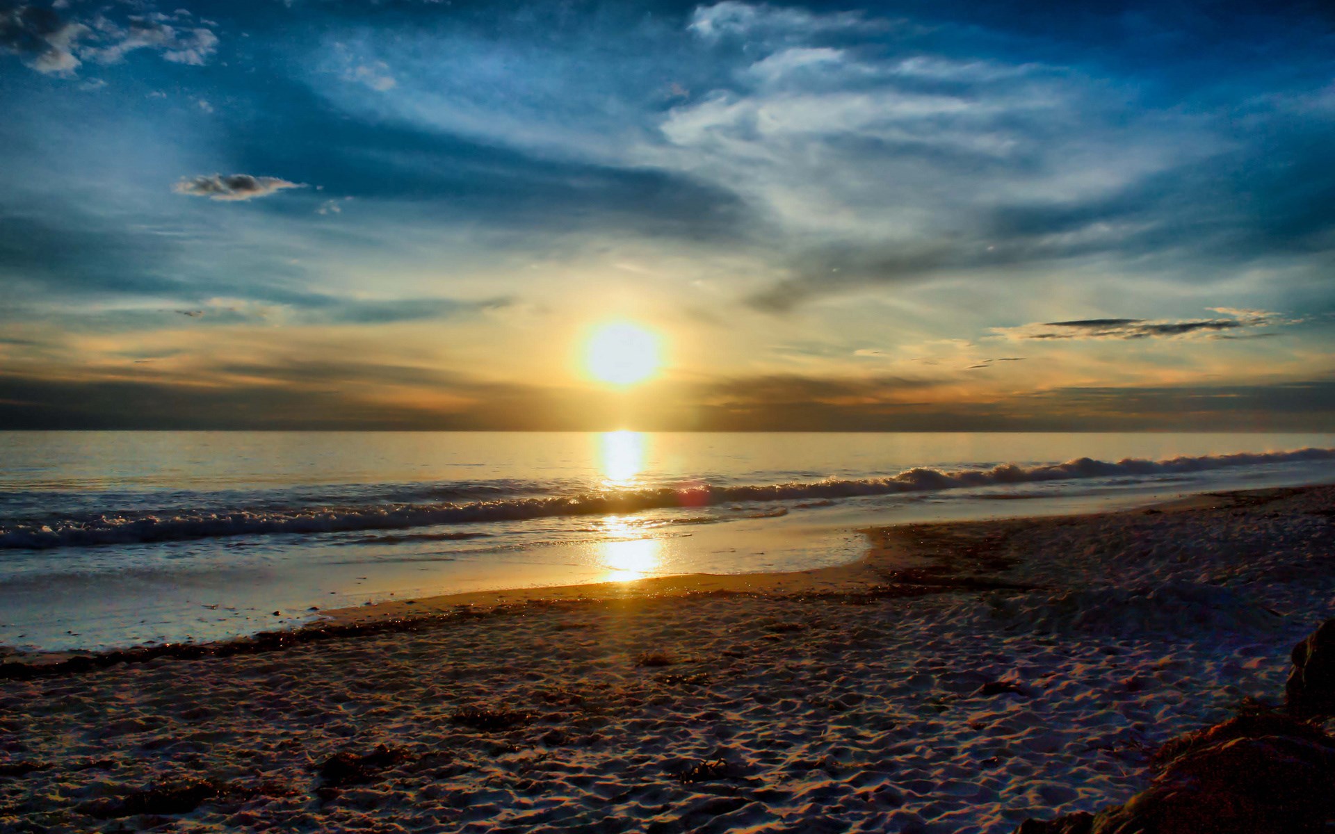 Sunset over the ocean with waves on the beach HD Wallpaper
