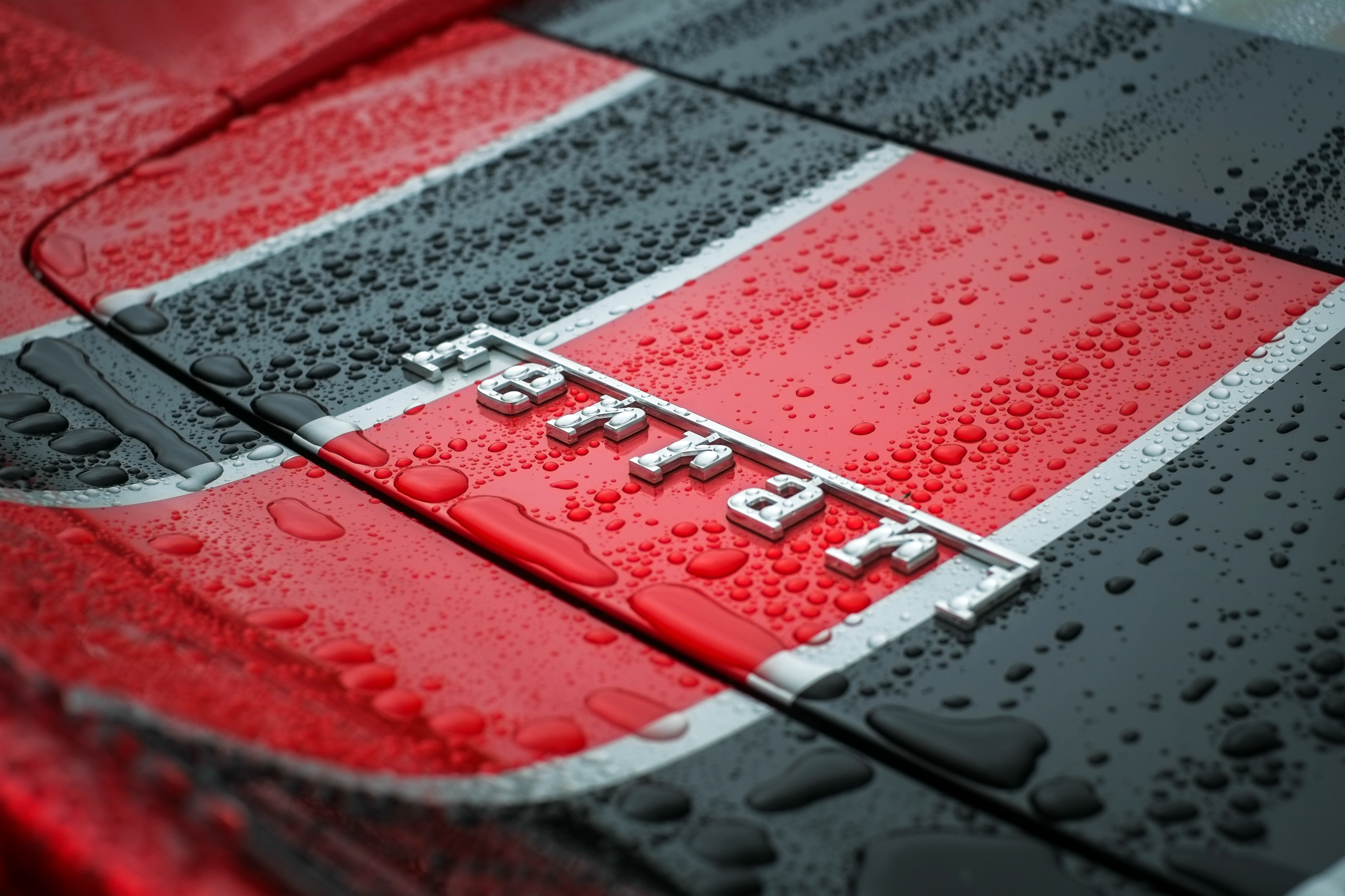Ferrari Logo on a Wet Car HD Wallpaper