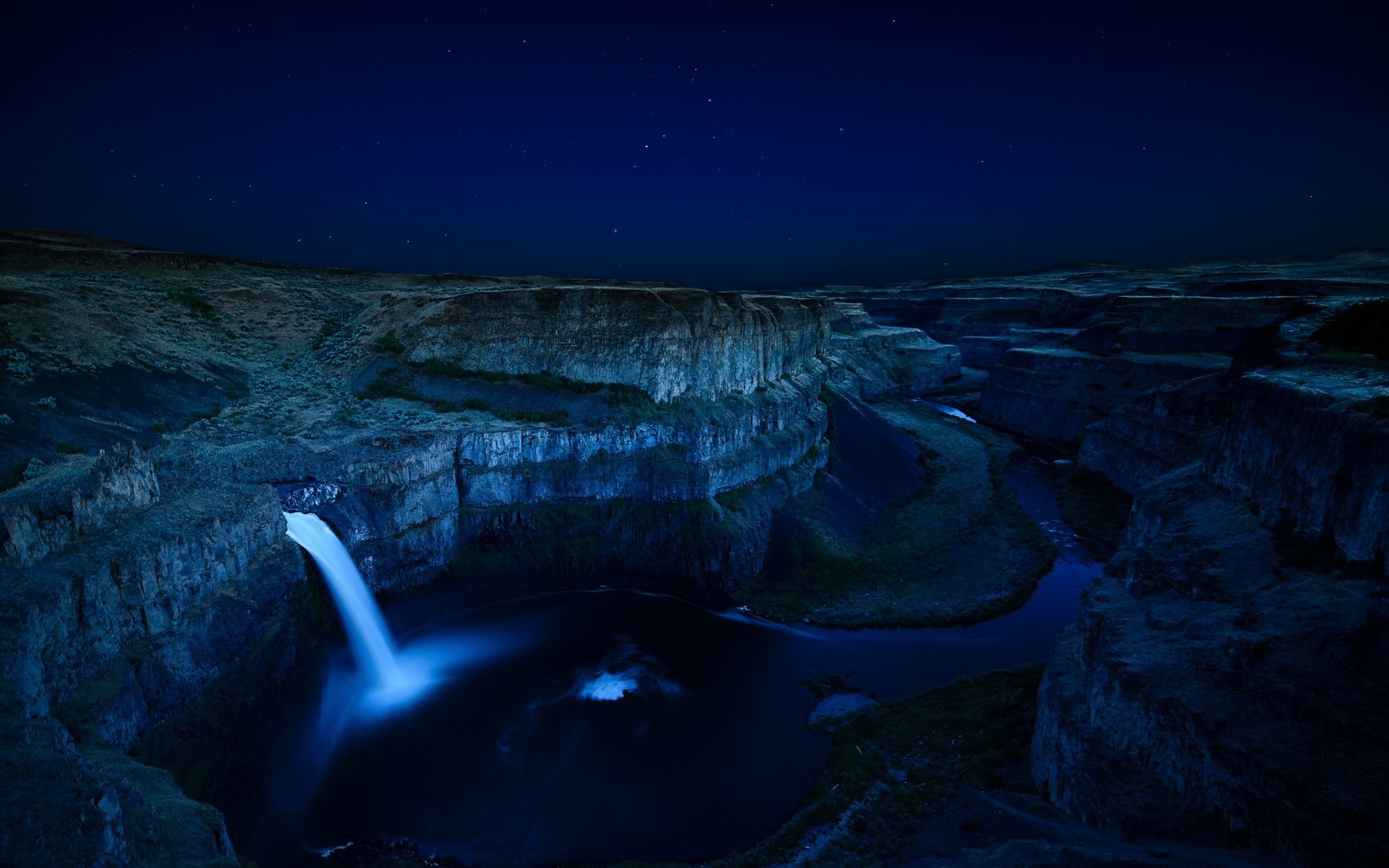 Waterfall in a canyon at night under stars HD Wallpaper