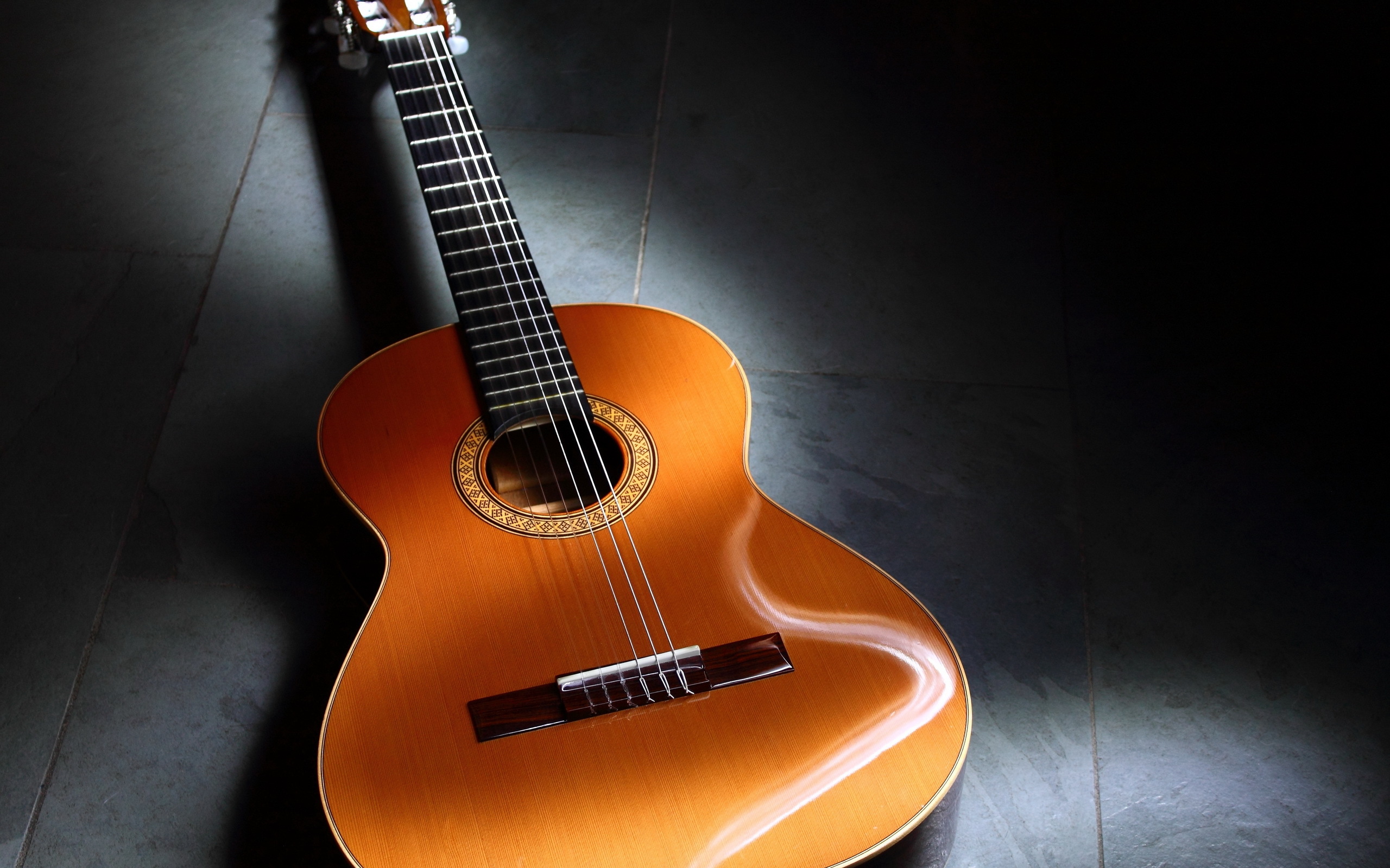 Acoustic guitar on a dark floor HD Wallpaper