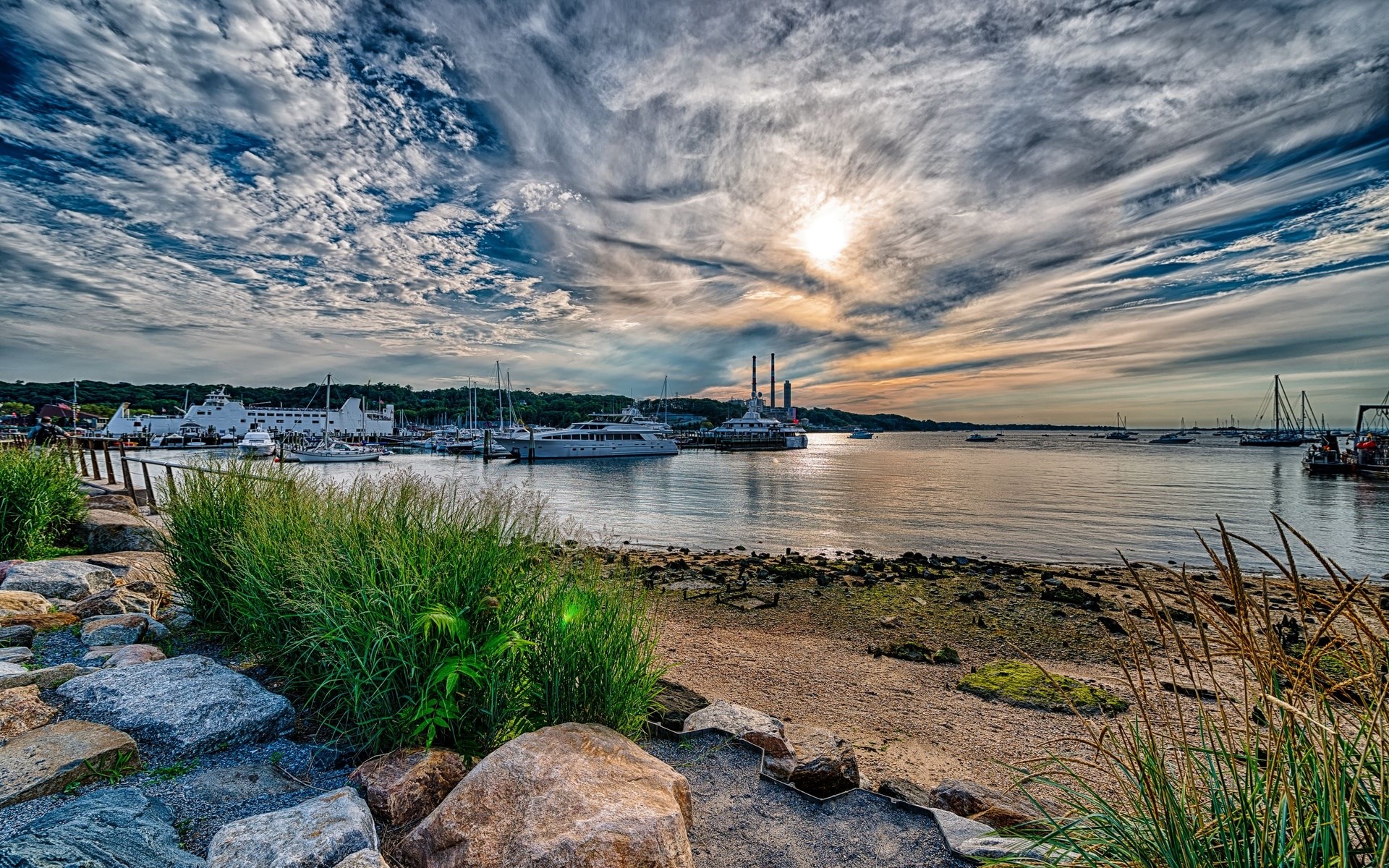Boats docked in a harbor at sunset with dramatic clouds HD Wallpaper