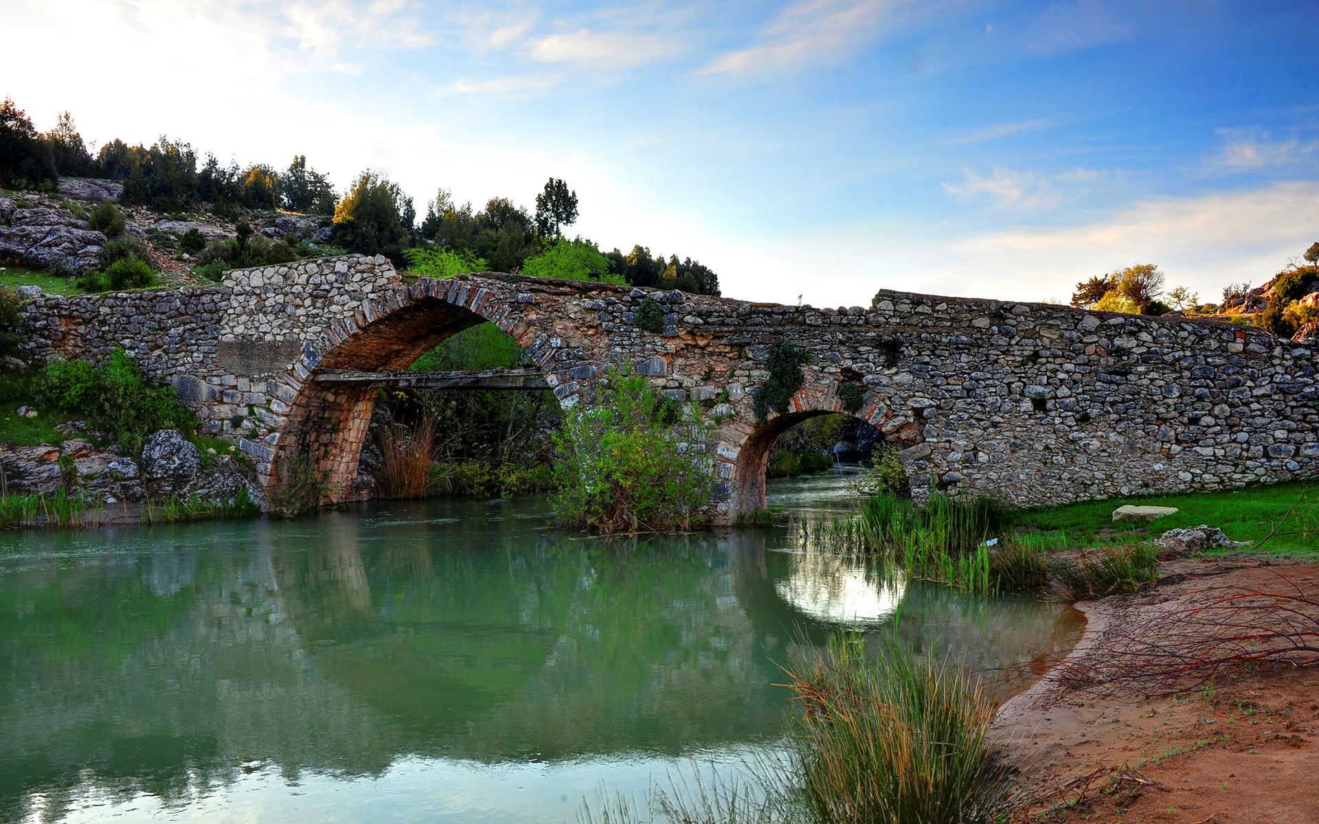 Stone bridge over a river with reflections HD Wallpaper