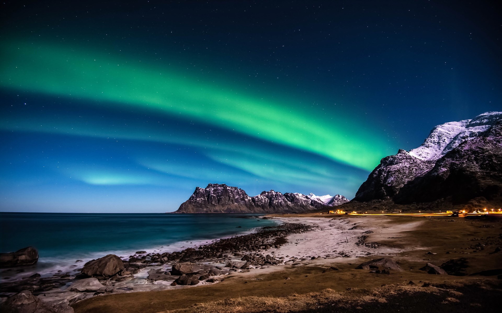 Aurora Borealis over a rocky beach and mountains HD Wallpaper