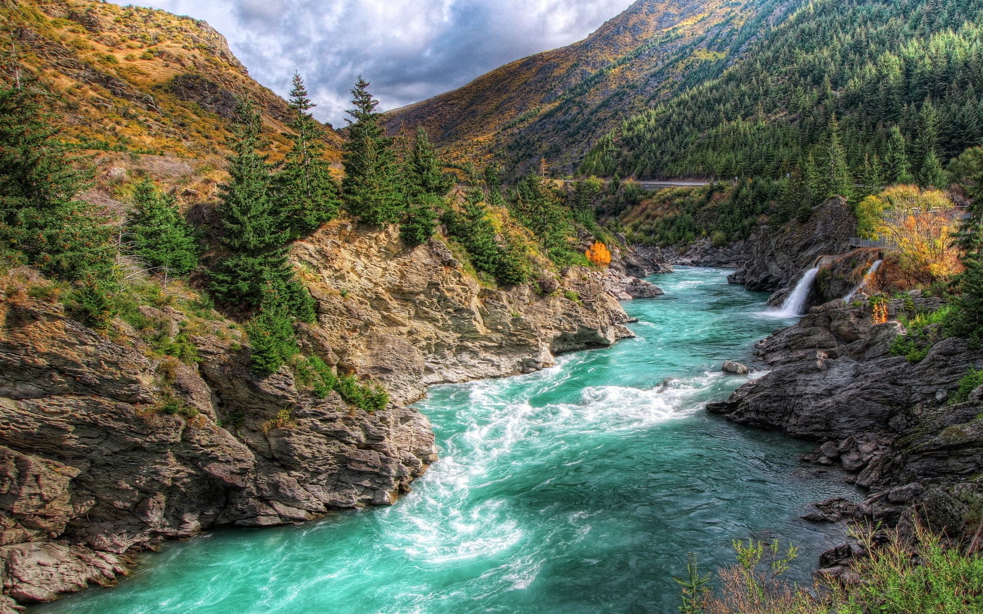 Turquoise river flowing through a rocky canyon with pine trees HD Wallpaper