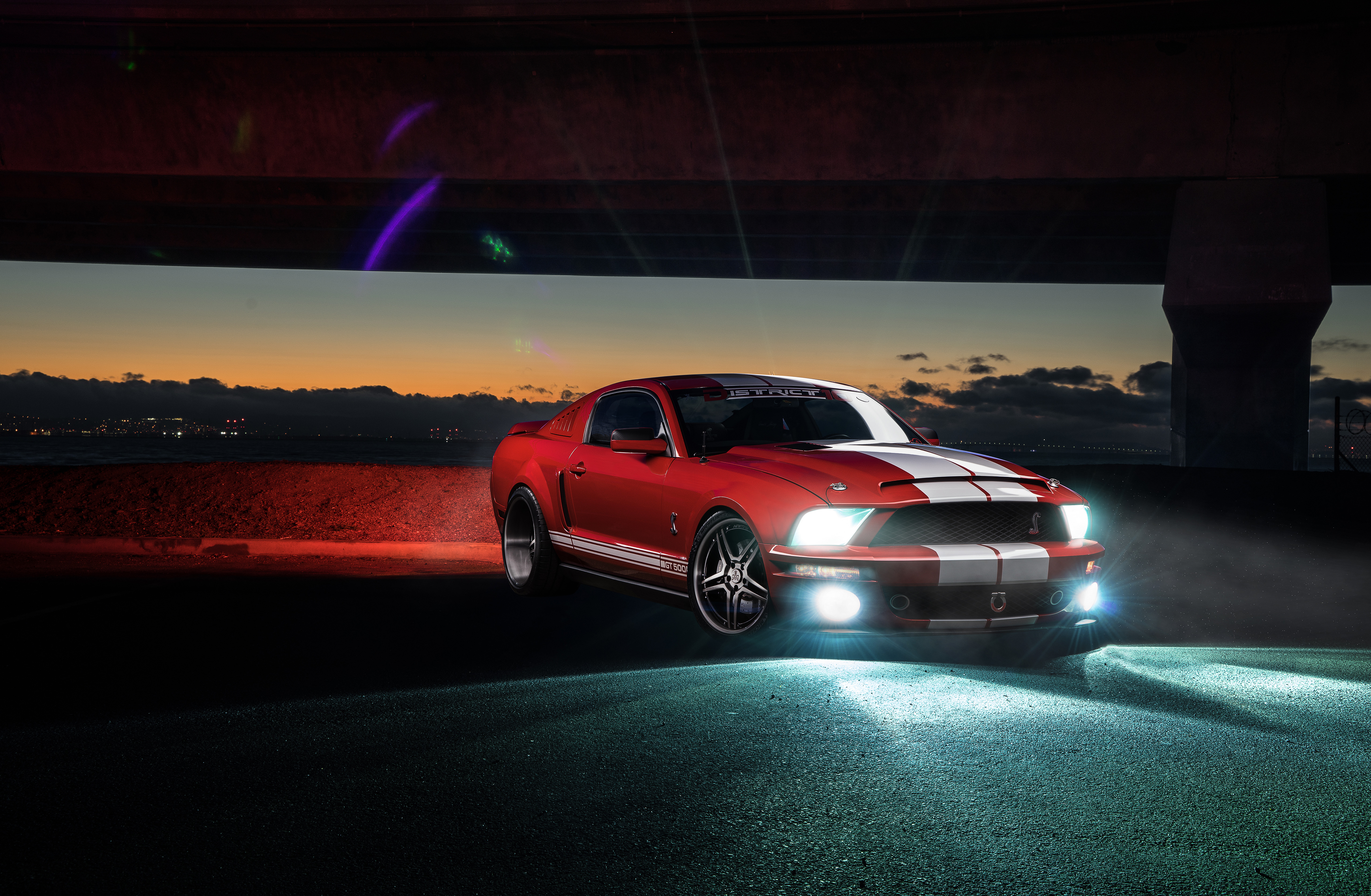 Red Shelby GT500 Ford Mustang under a bridge at dusk HD Wallpaper