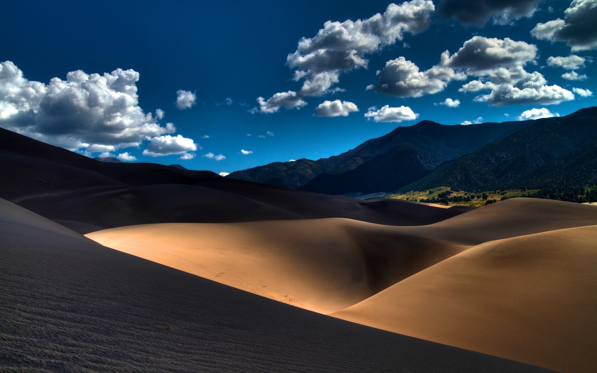Sand dunes with mountains and clouds HD Wallpaper