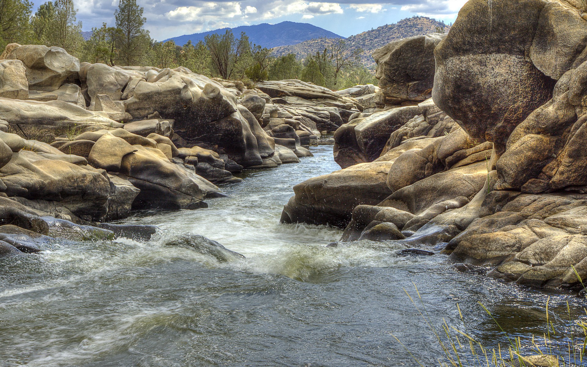River flowing through rocky canyon with mountains HD Wallpaper