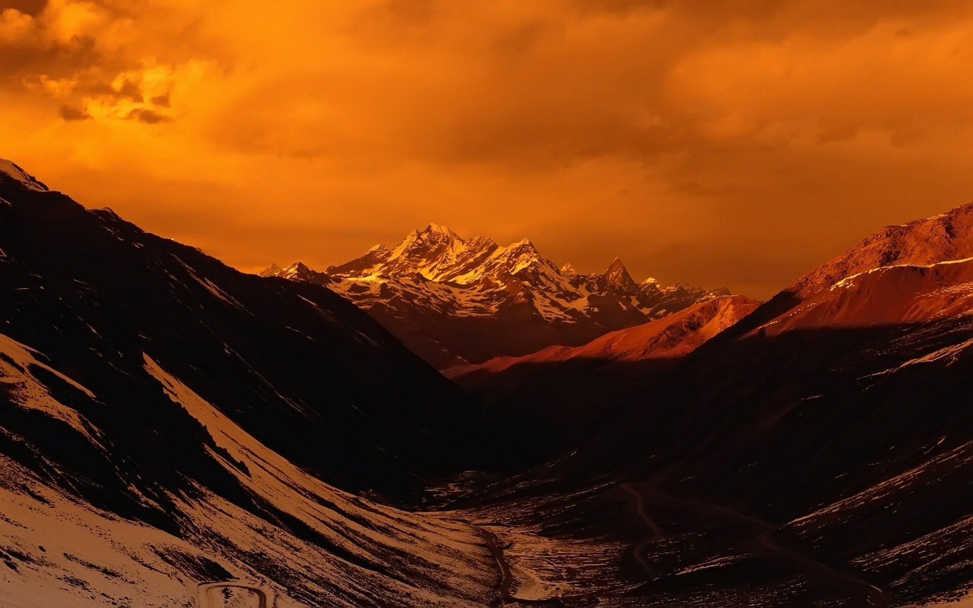 Mountain range under orange sky HD Wallpaper