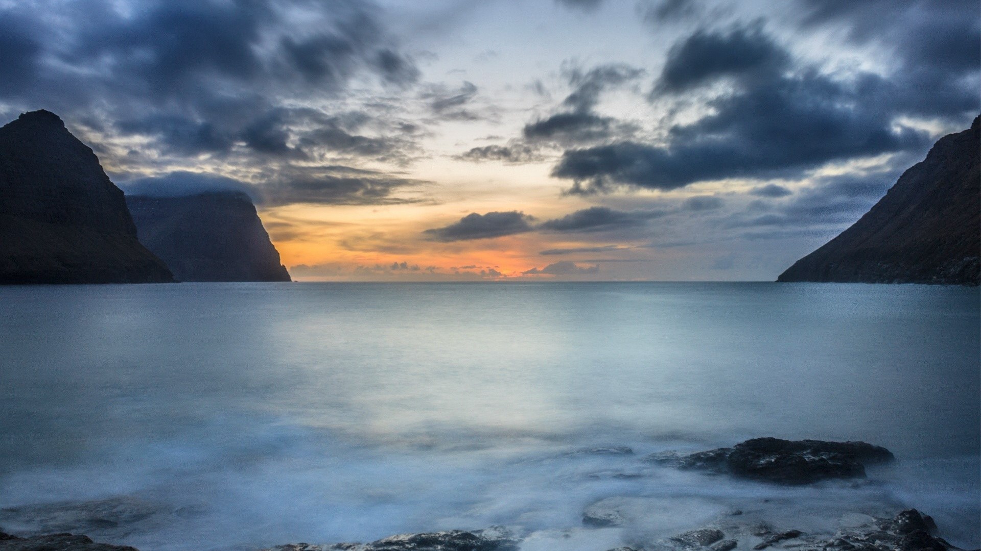 Ocean bay with mountains and cloudy sunset sky HD Wallpaper