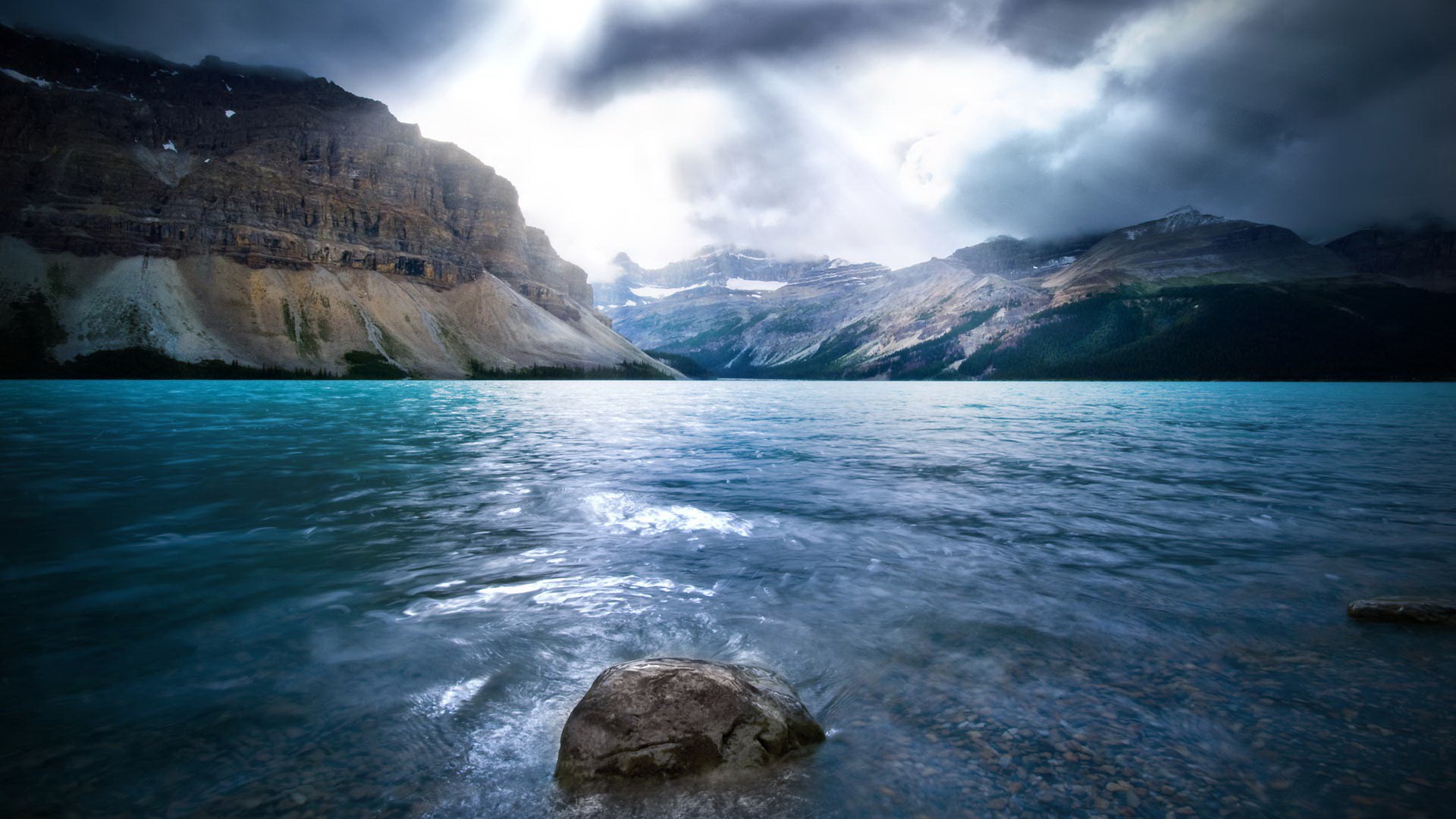 Turquoise lake and rocky mountains under cloudy sky HD Wallpaper