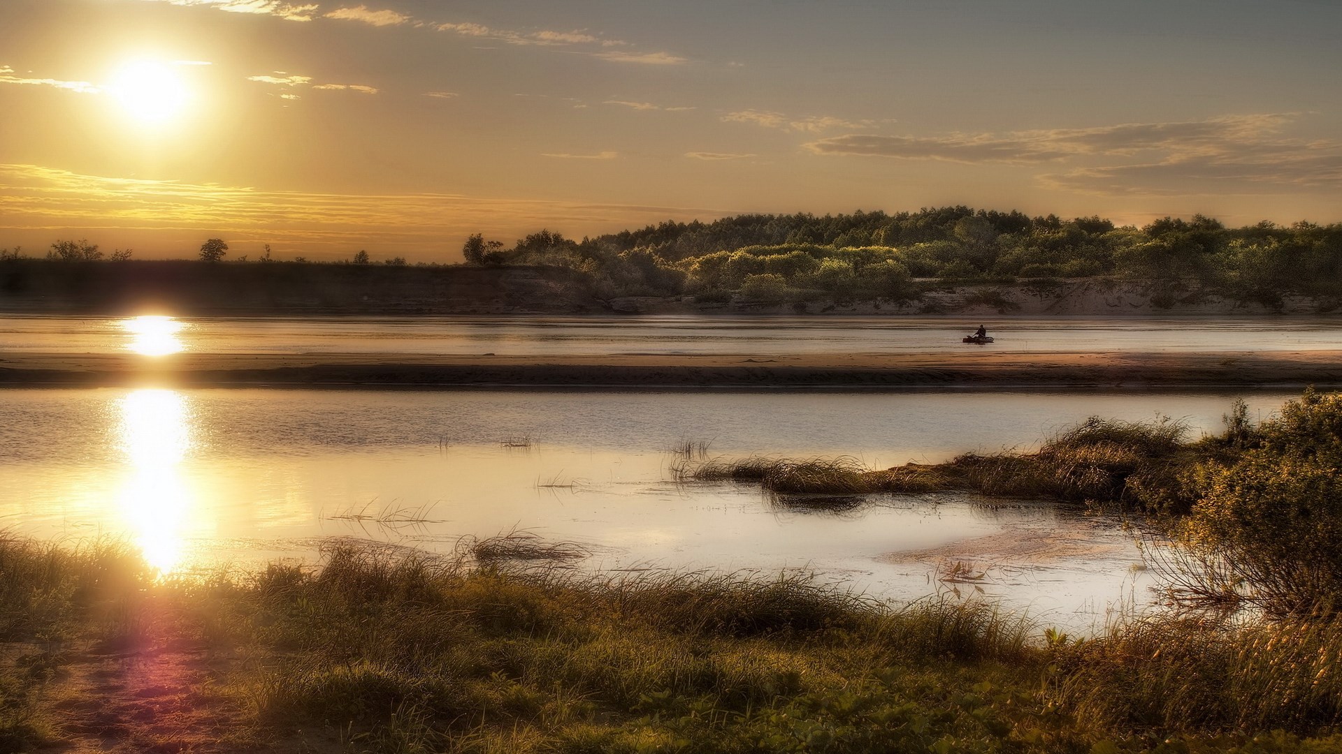 Sunset over a river with a lone fisherman HD Wallpaper