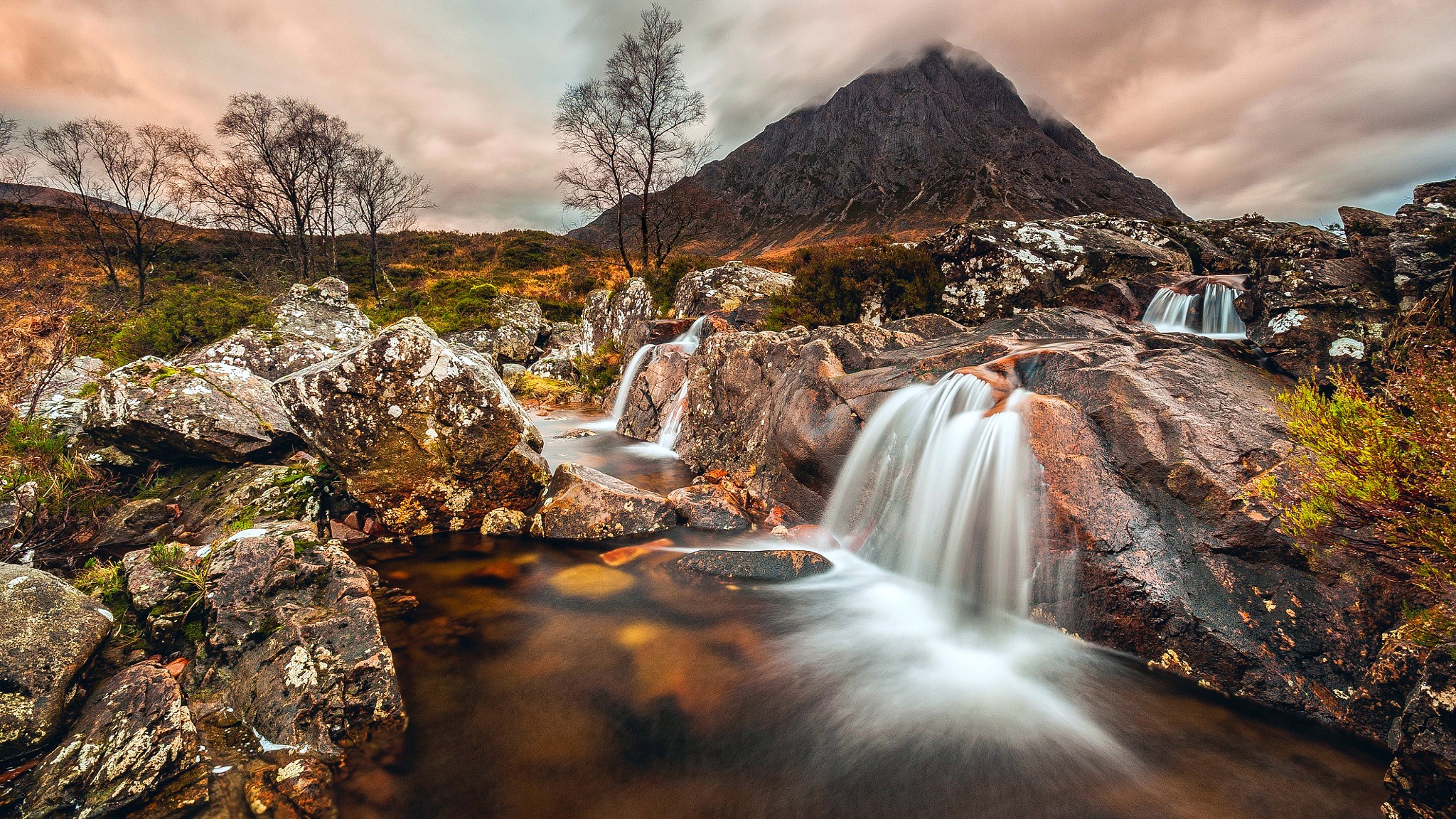 Mountain landscape with waterfalls and rocky terrain HD Wallpaper
