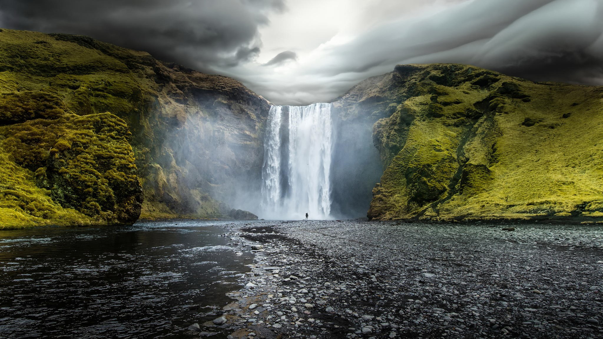 Skogafoss Waterfall in Iceland with a lone figure HD Wallpaper