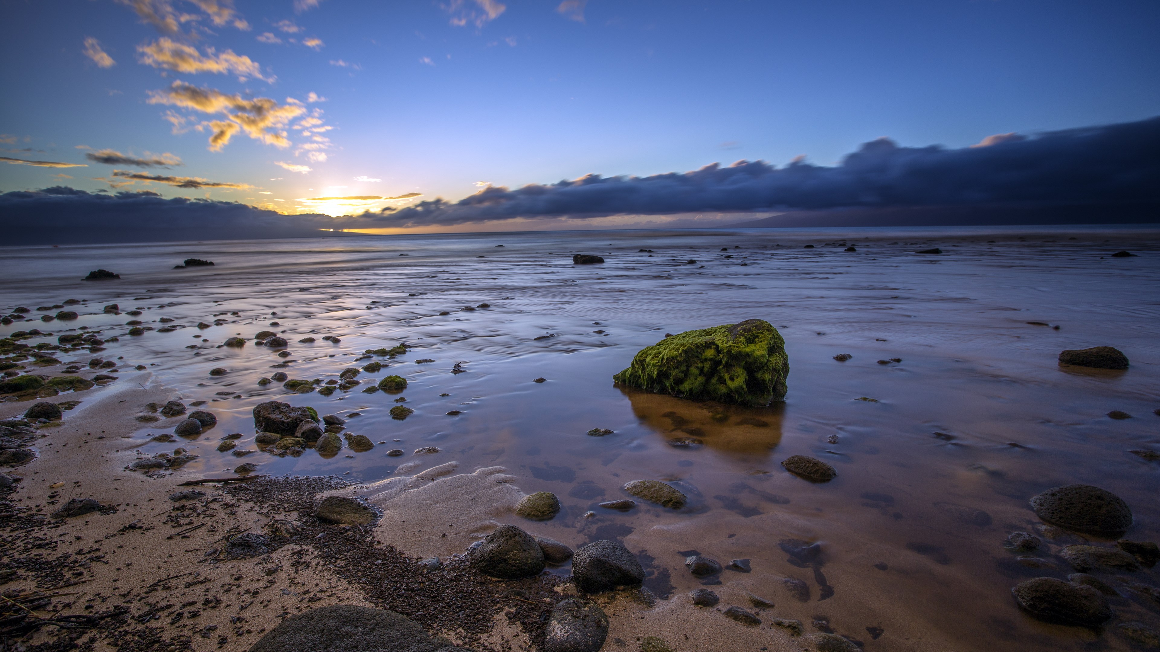 Rocky beach at sunset with dramatic clouds HD Wallpaper