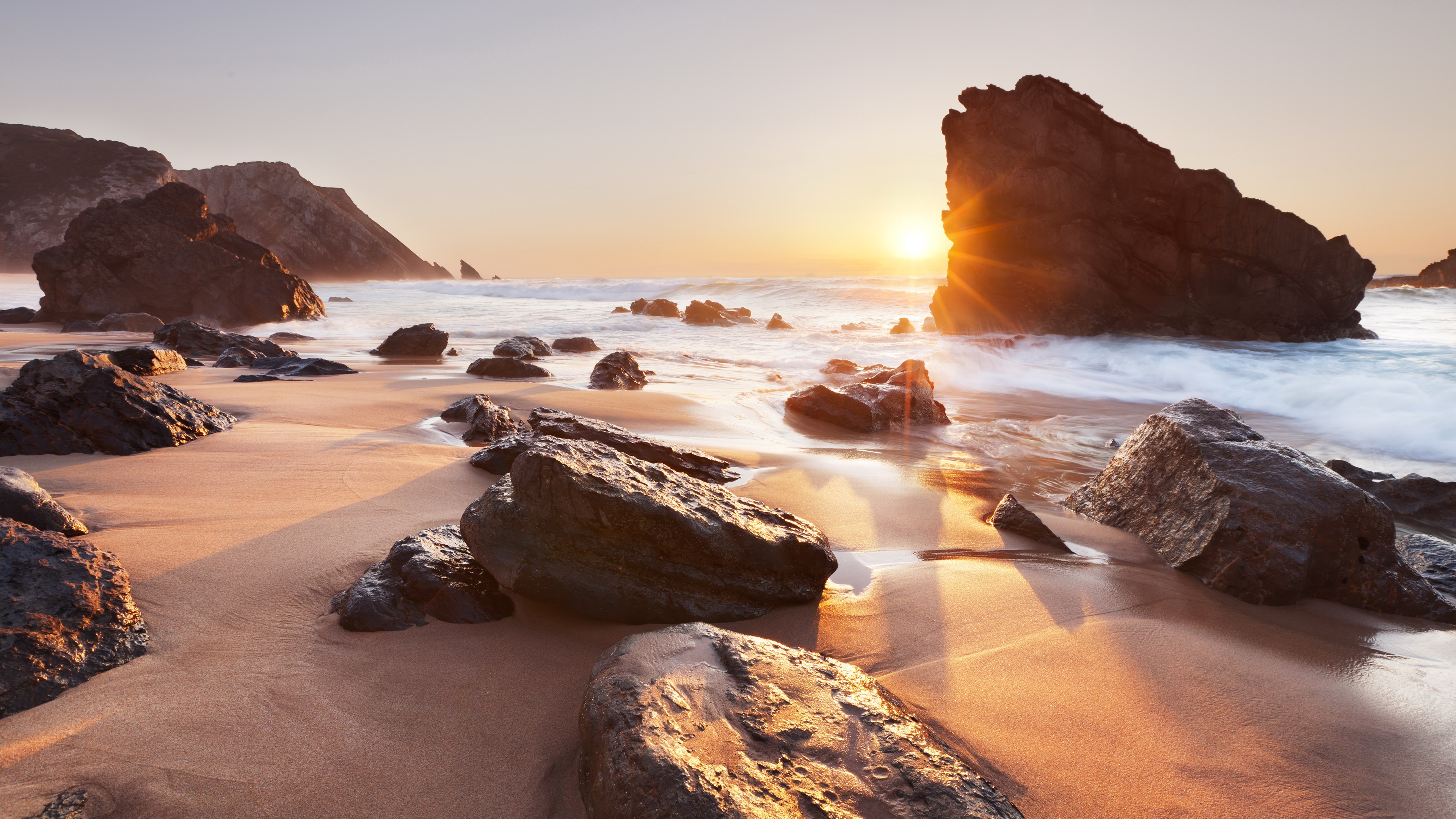 Sunset over rocky beach with ocean waves HD Wallpaper