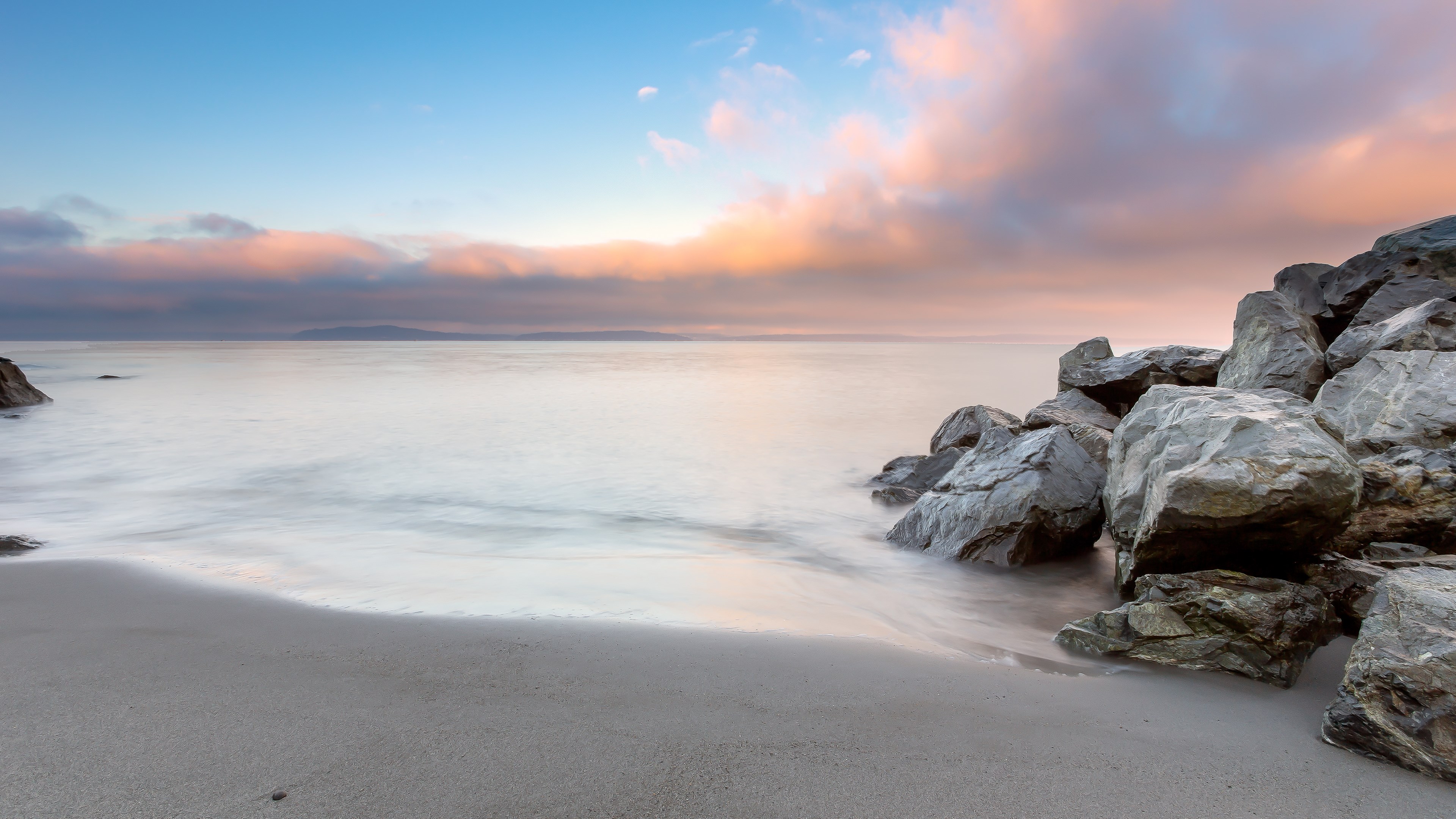 Long exposure of a rocky beach at sunset HD Wallpaper