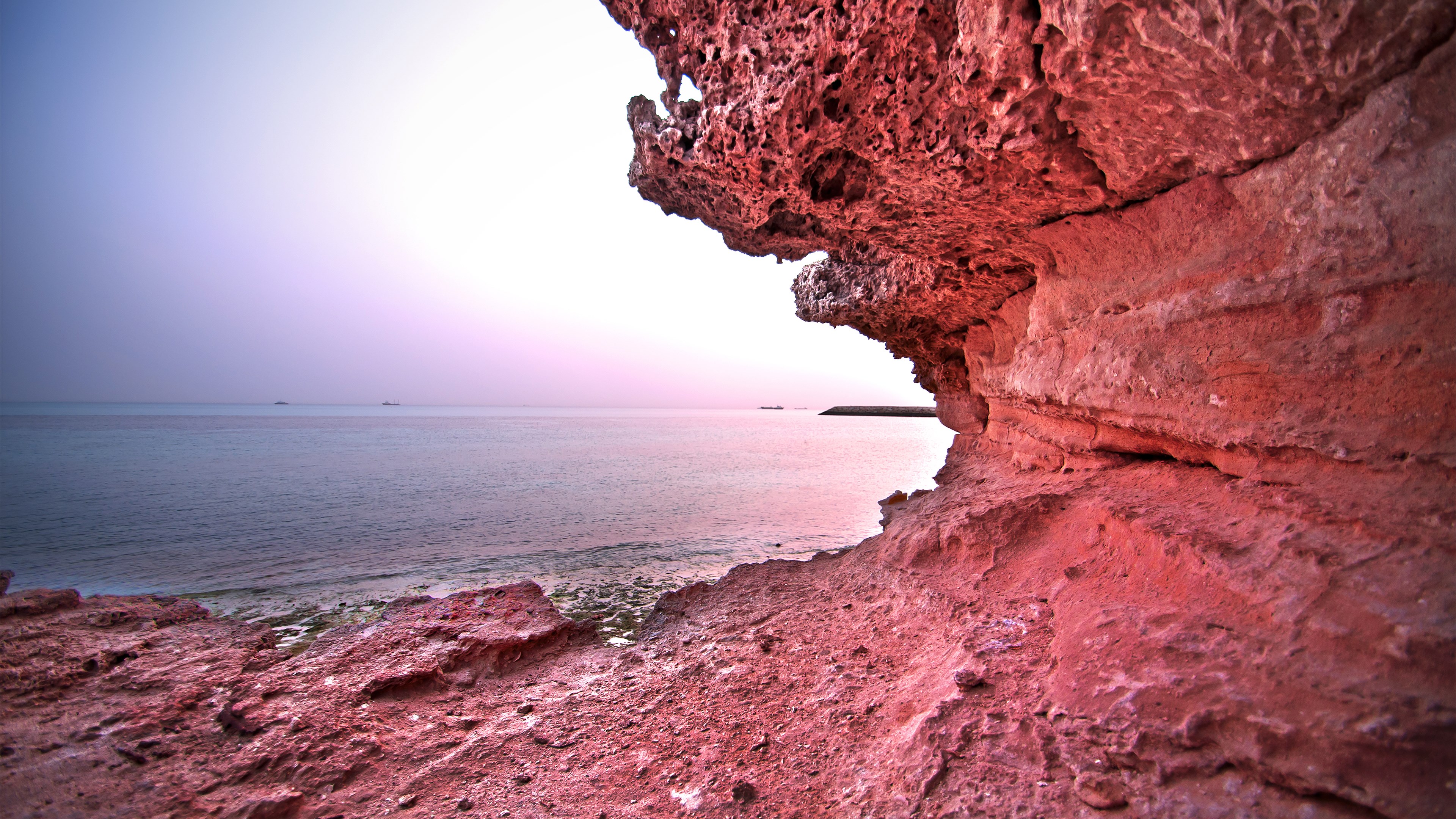 Red rock formations on a beach at sunset HD Wallpaper
