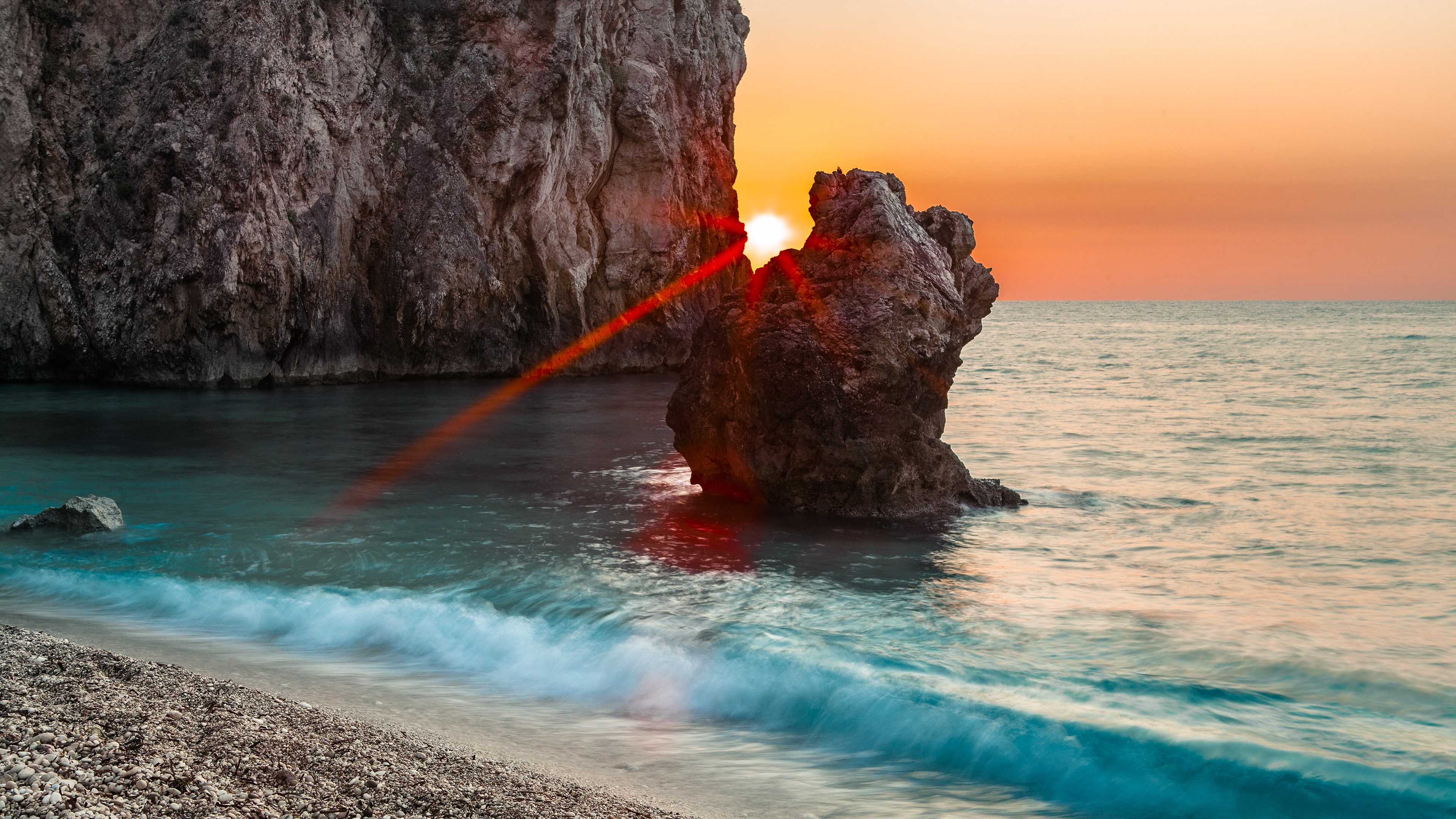 Sunset over the sea with rock formations HD Wallpaper