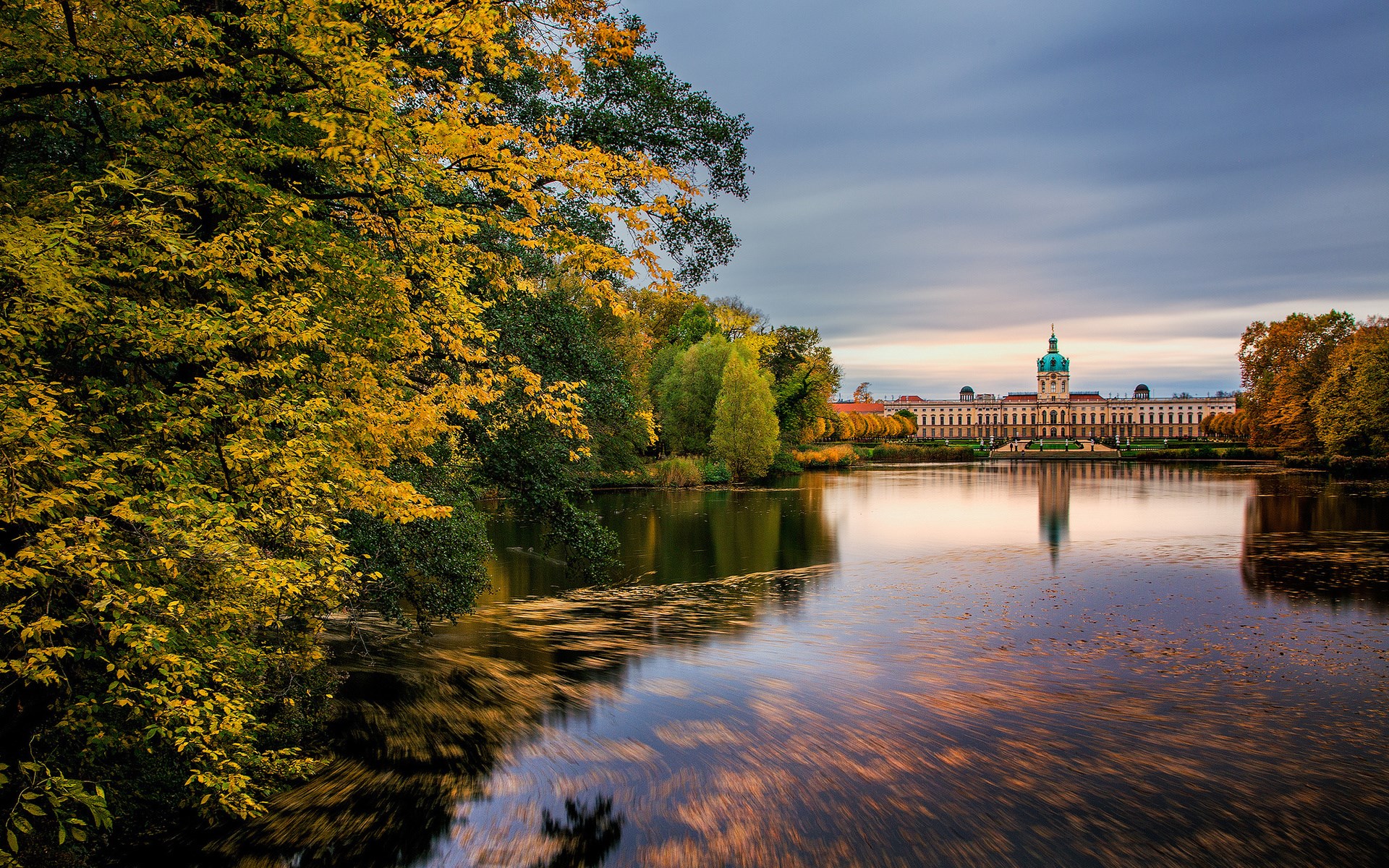 Palace reflected in a lake during autumn HD Wallpaper