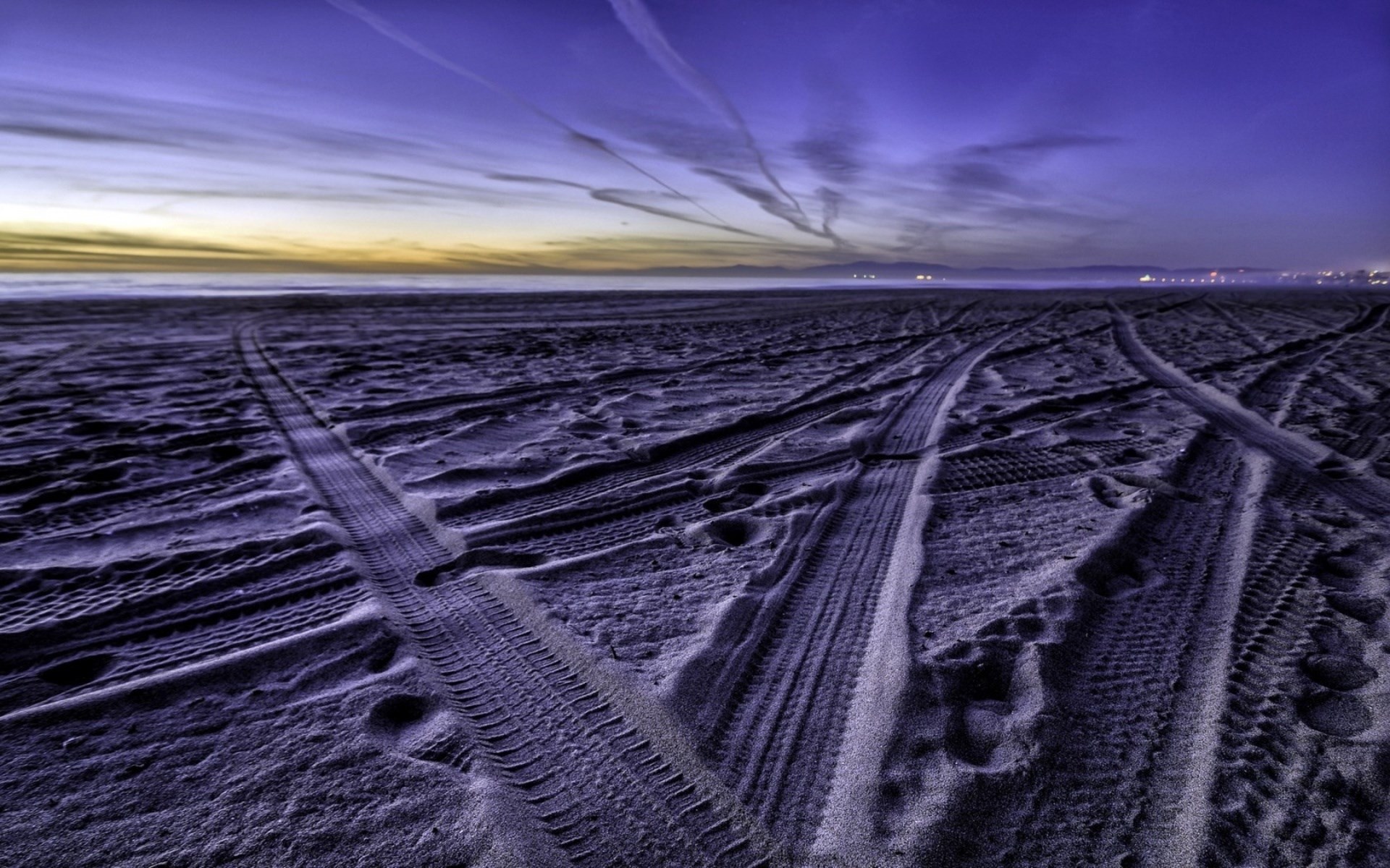 Tire tracks on a beach at dusk HD Wallpaper