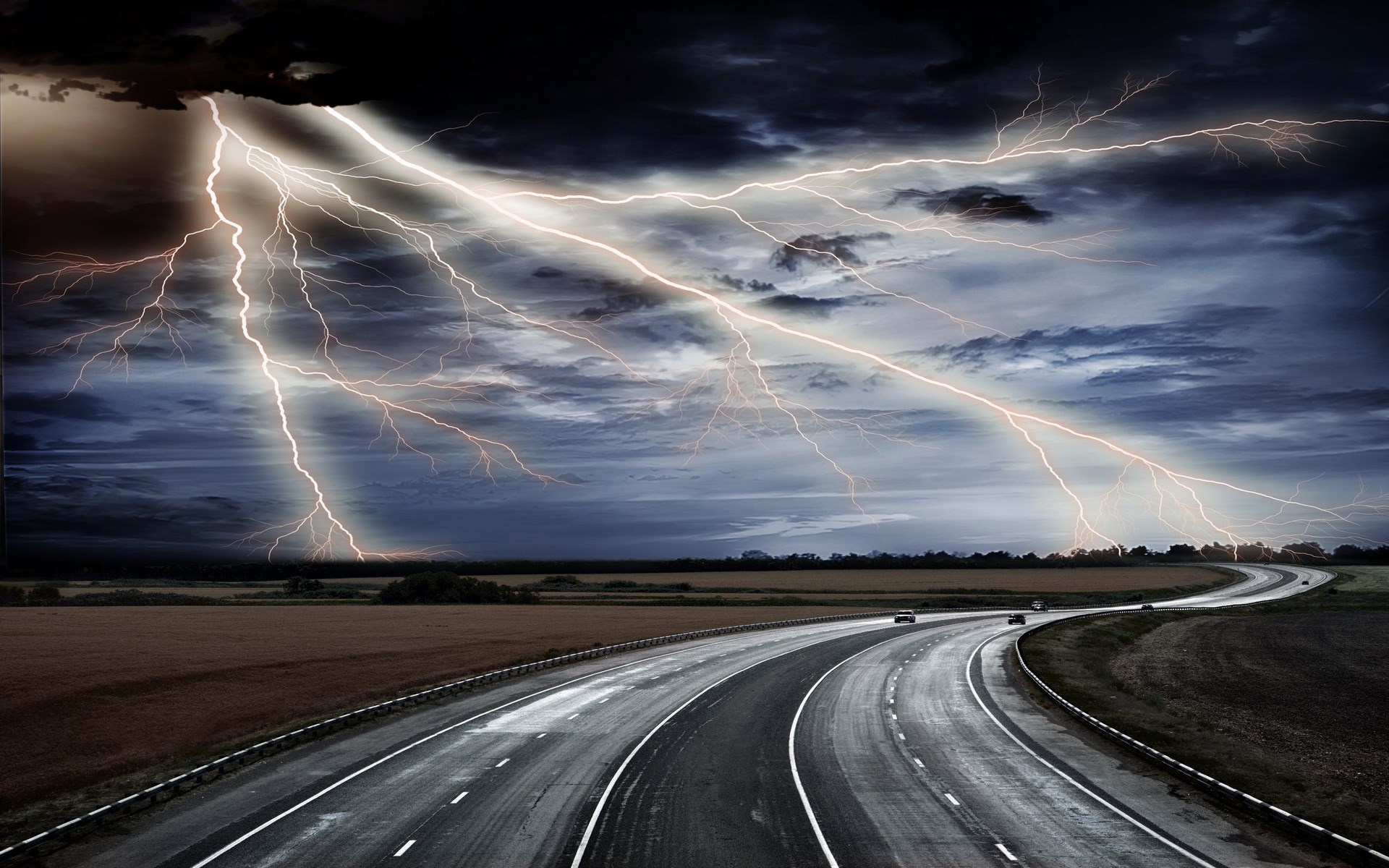 Lightning strikes over a highway during a storm HD Wallpaper