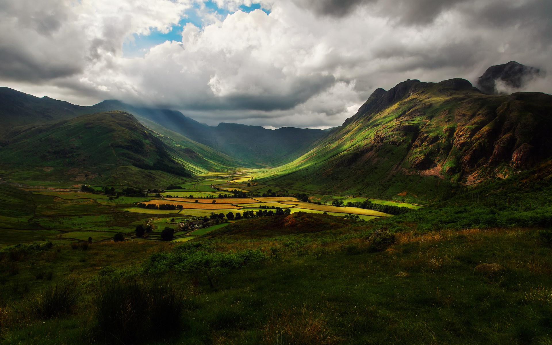 Valley with green hills and dramatic clouds HD Wallpaper