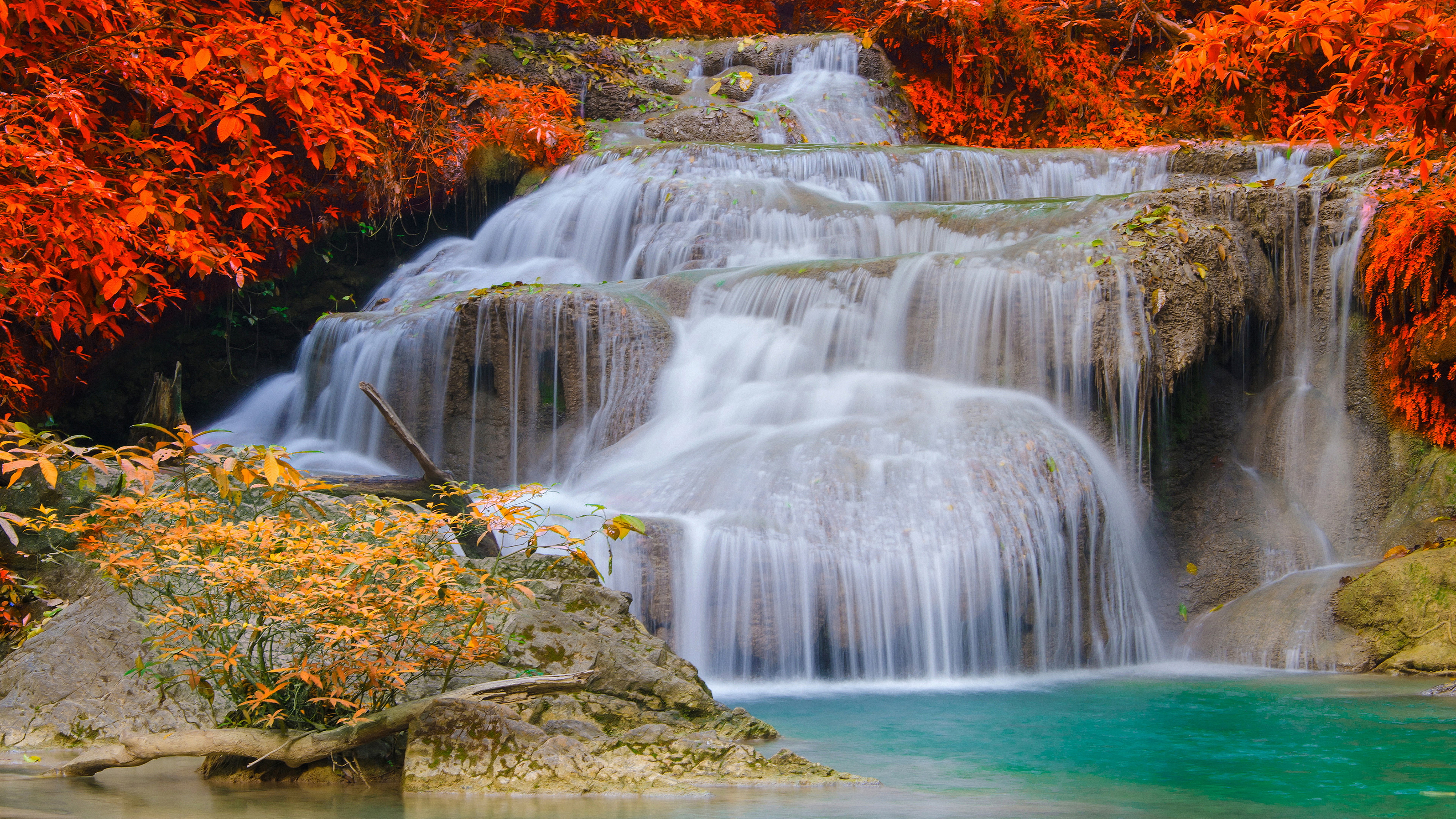 Tiered waterfall with orange foliage and turquoise pool HD Wallpaper