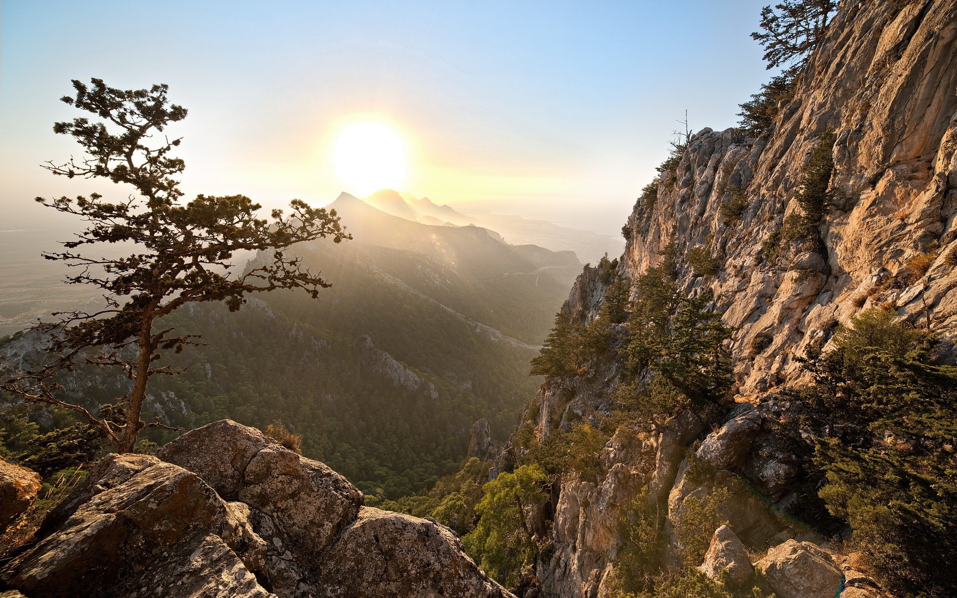 Sunrise over a mountain valley with rocky cliffs HD Wallpaper